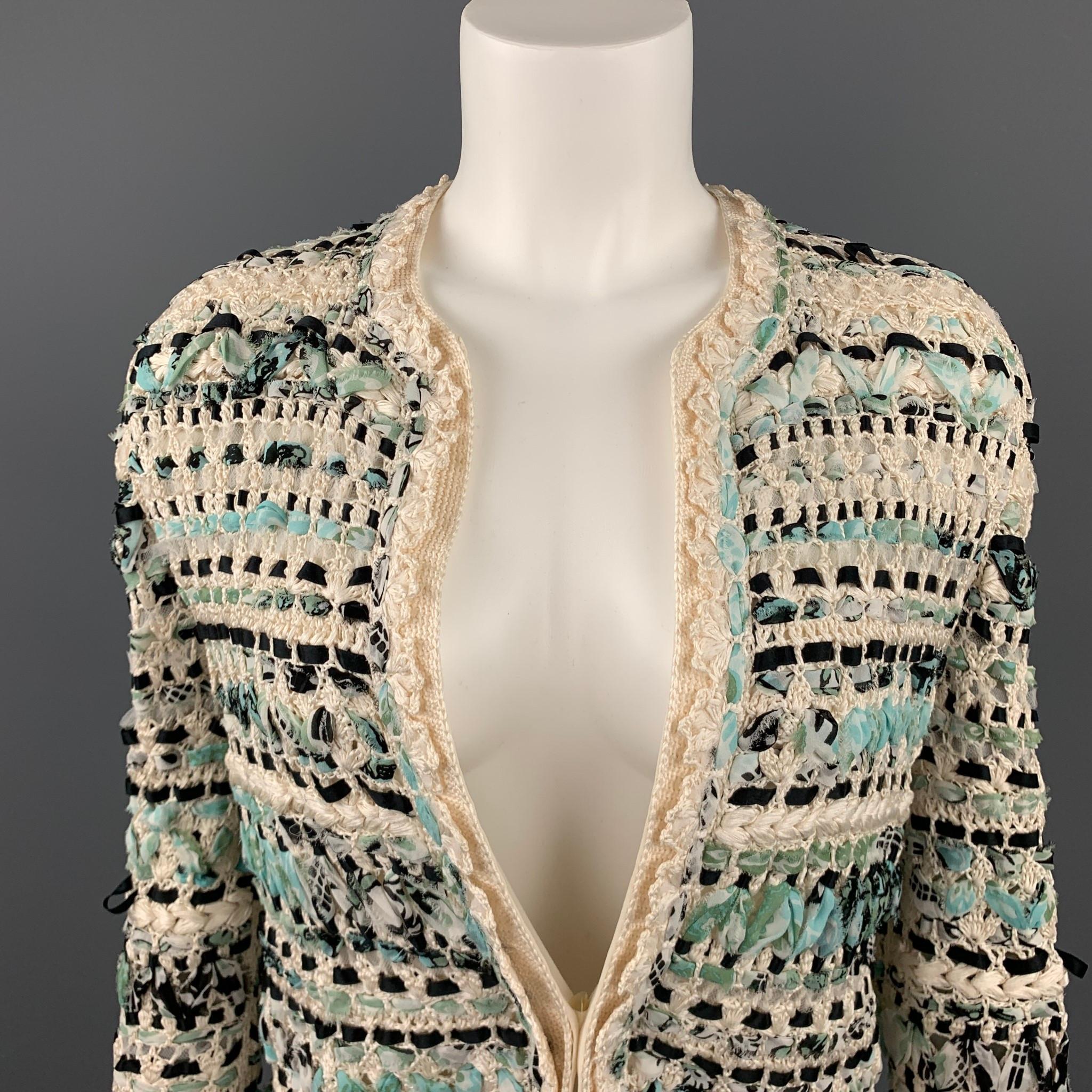 OSCAR DE LA RENTA open front cardigan jacket comes in a light creamy beige silk crochet knit with teal blue and black chiffon and ribbon woven throughout with a round collar, patch pockets, and cream chiffon half liner.

Good Pre-Owned
