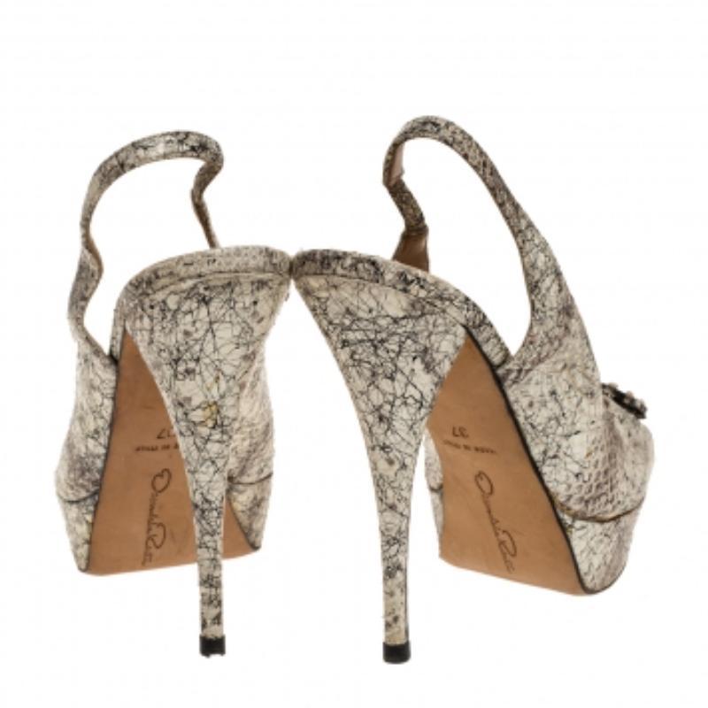 Oscar de la Renta brings you all the latest trends in fashion with these sandals. Wear these snake print leather sandals when you go out and watch heads turn. They come in white & black hues, have peep toes, platforms, slingbacks, bow detailing on
