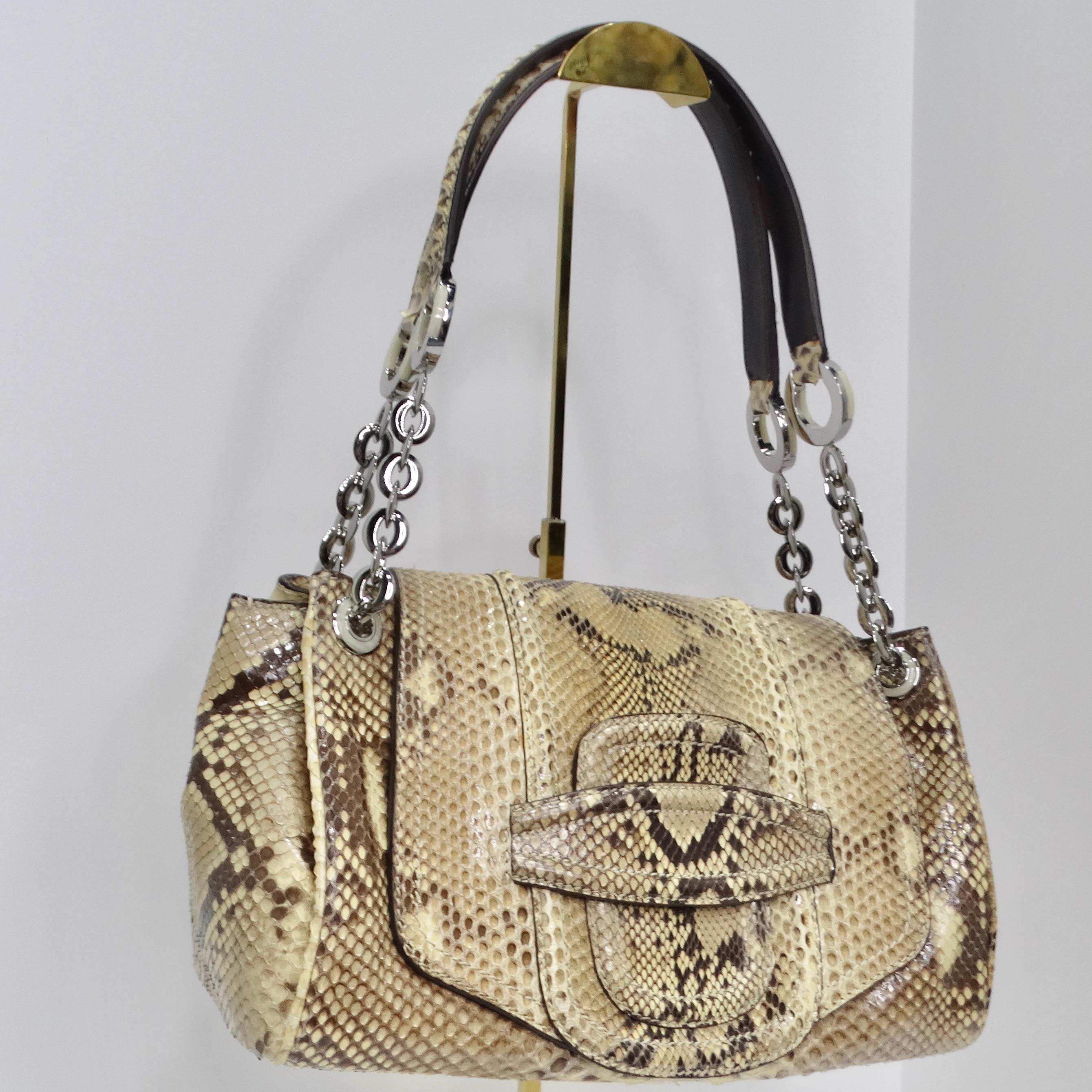 Elevate your style with this Oscar De La Renta Snakeskin Shoulder Bag – a true embodiment of luxury and sophistication. This classic everyday fold-over shoulder bag is crafted from magnificent snakeskin, exuding timeless elegance with its exotic