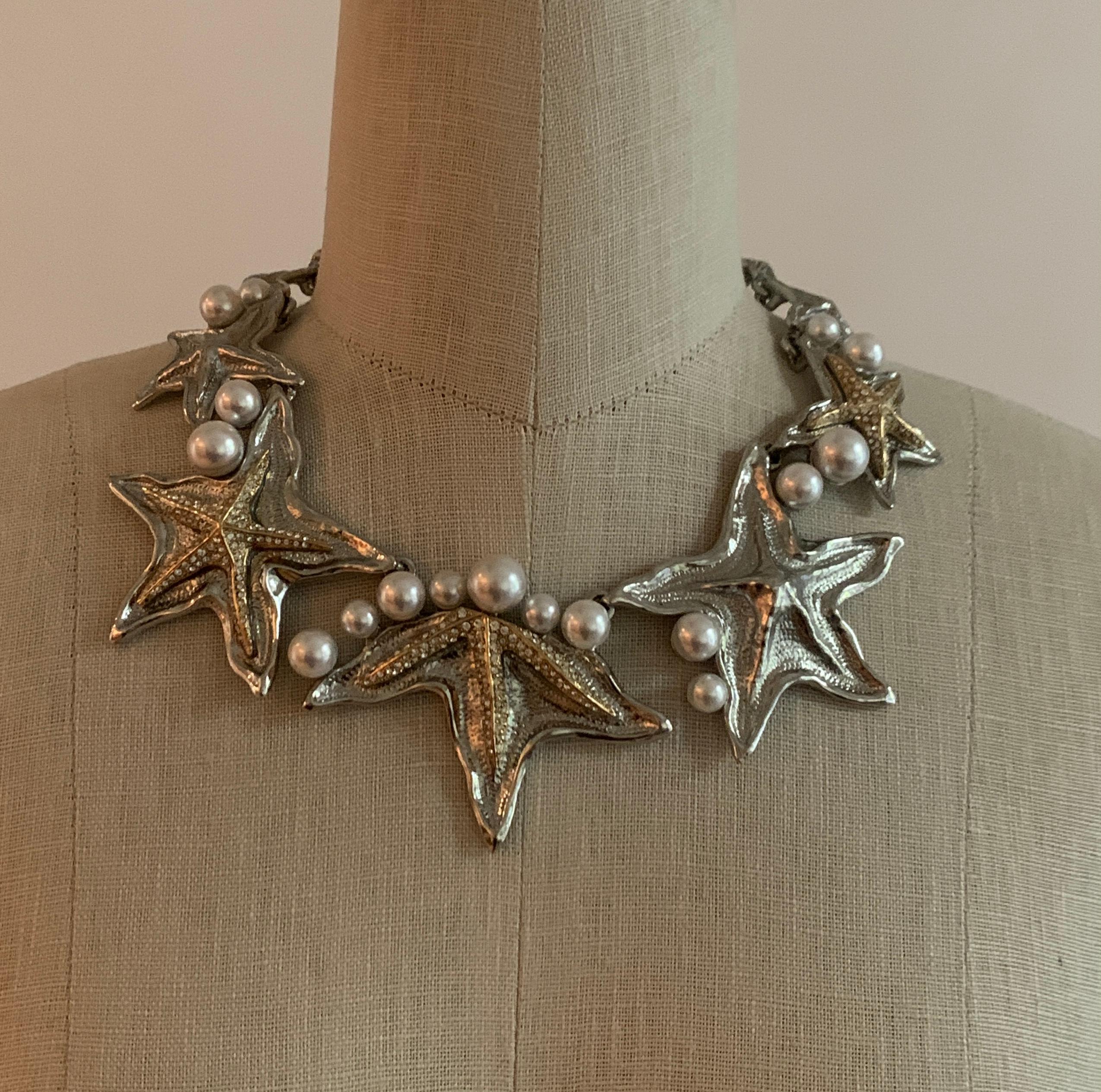 Oscar de la Renta statement choker necklace featuring silver and gold tone star fish with faux pearl and Swarovski crystal accents. Perfect for glamming it up at the beach or pool, or for a nautical themed party! 

Signed 'Oscar de la Renta' at