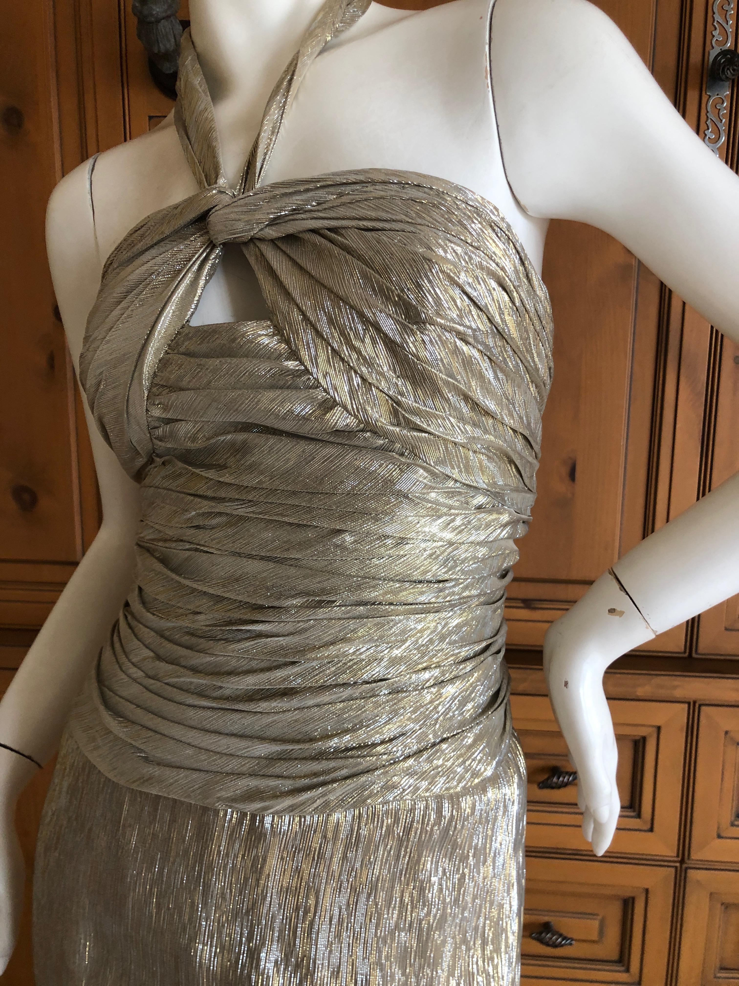 Oscar de la Renta Stunning Metallic Silk Halter Style Evening Dress with Keyhole Detail 
Simply Stunning. Please use the zoom feature to see al the remarkable details.
This shows both gold and silver metallics.
Size 6
 Bust 34