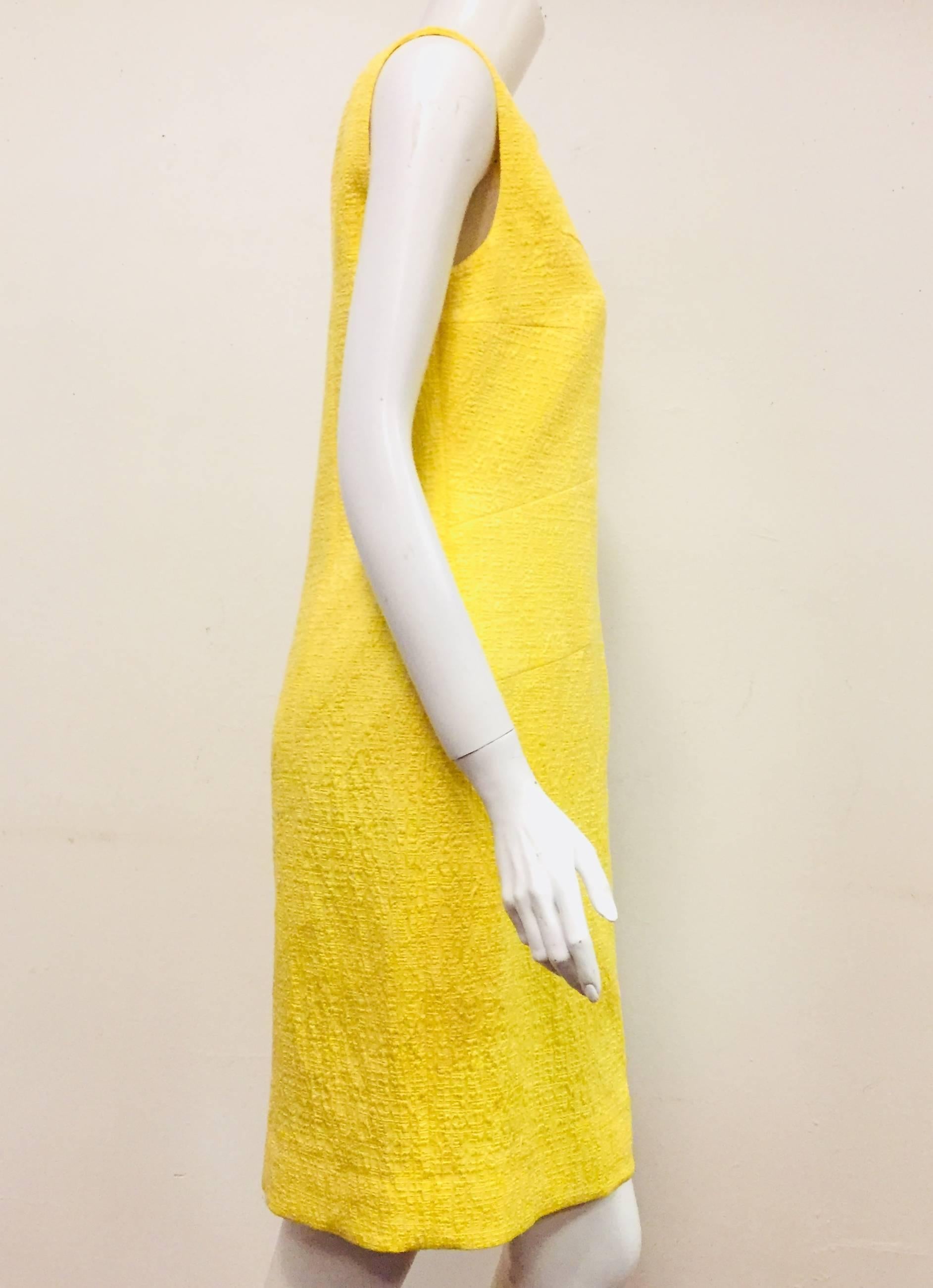 Oscar de la Renta's yellow sleeveless dress outshines the sun!  This cotton blend dress is bright and beautiful and perfect for Spring.  Round neckline and back zipper for closure.  Dramatic darts decorate the front of dress from bust line to upper