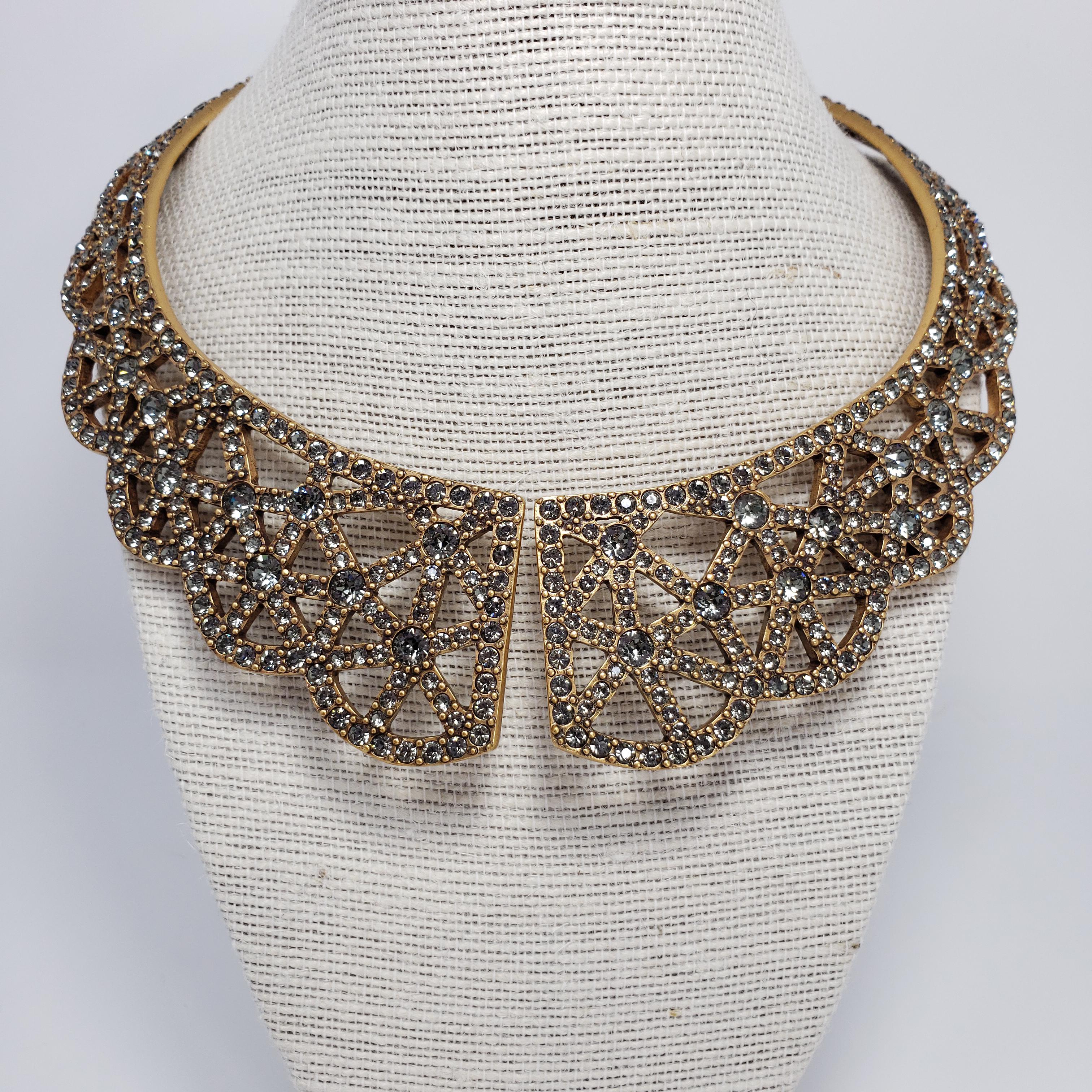 Golden collar necklace by Oscar de la Renta. Smoky gray crystals set in decorative patterns.  Spring-hinge collar.

Hallmarks: Oscar de la Renta, Made in USA
Inner circumference approx 40 cm / 15.75 inches