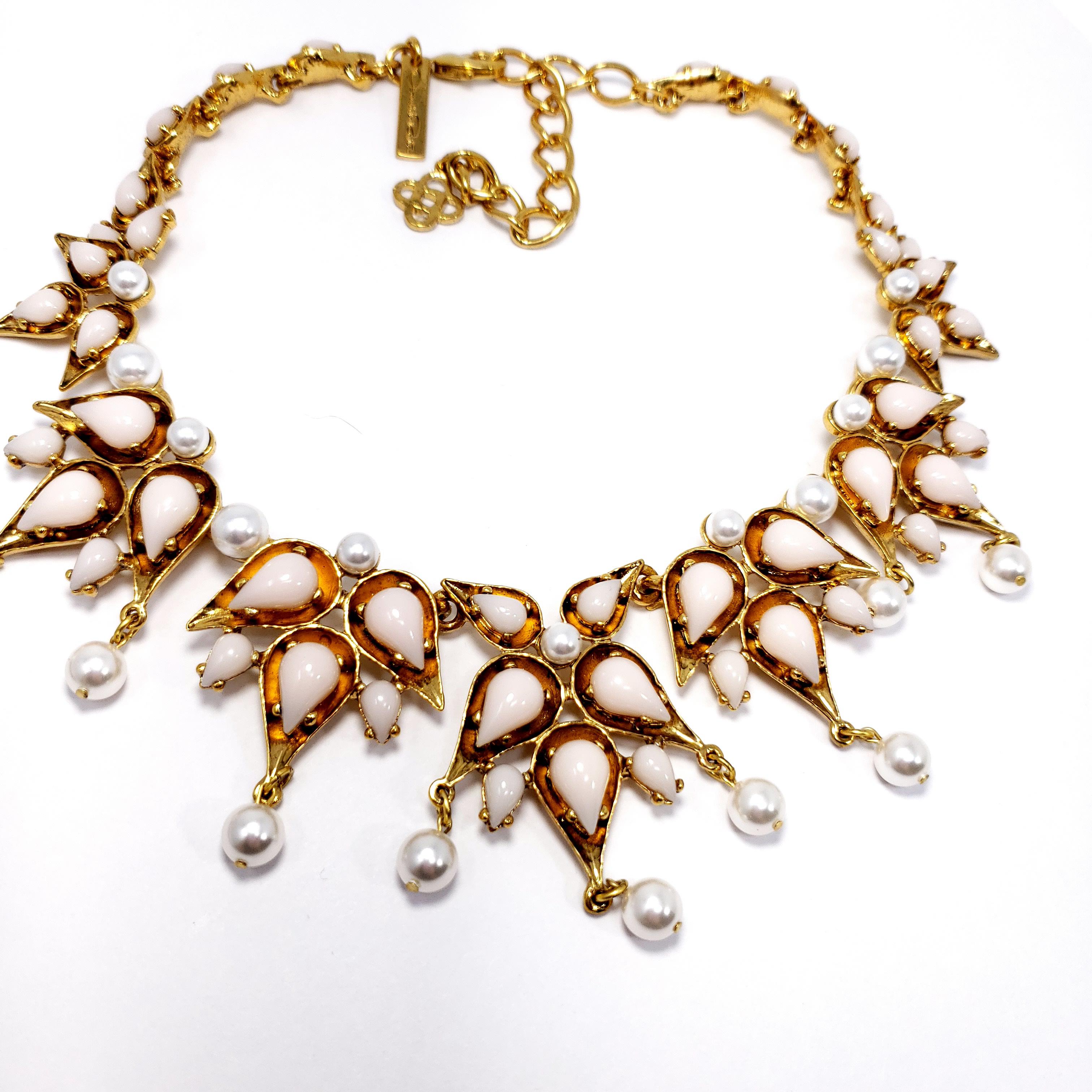 Necklace by Oscar de la Renta featuring prong-set white glass tear-drop cabochons, accented with dangling faux pearls. Set on antique 22K yellow gold plated necklace.

Hallmarks: Oscar de la Renta, Made in USA
Necklace length 38 cm / 15 in plus 8cm