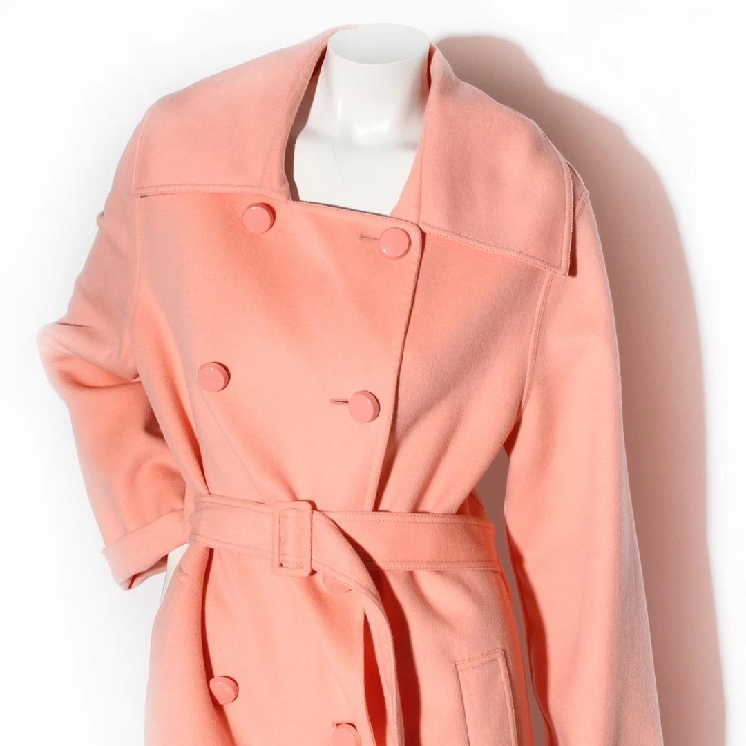 Oscar de la Renta Trench Coat 
Pink Wool blend
Double breasted 
Ten pink buttons down front of coat 
Two broad welt side pocket 
Oversize shawl collar 
Square neckline 
Has attached belt with fabric covered buckle 
Excellent condition; Preloved with