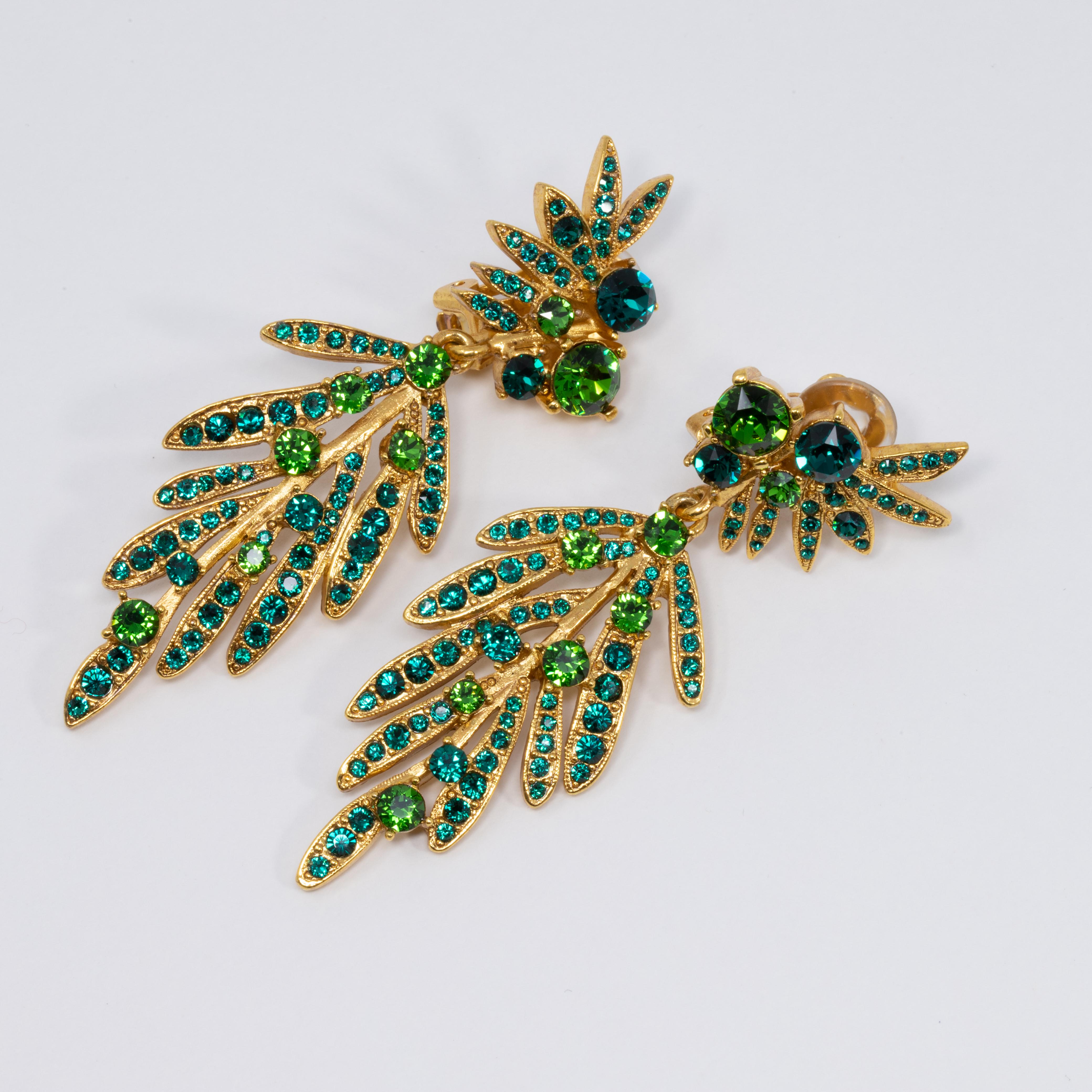 An exquisite pair of earrings by Oscar de la Renta! Each earring features dangling gold-plated tropical leaves accented with green Swarovski crystals. 

Hallmarks: Oscar de la Renta, Made in USA