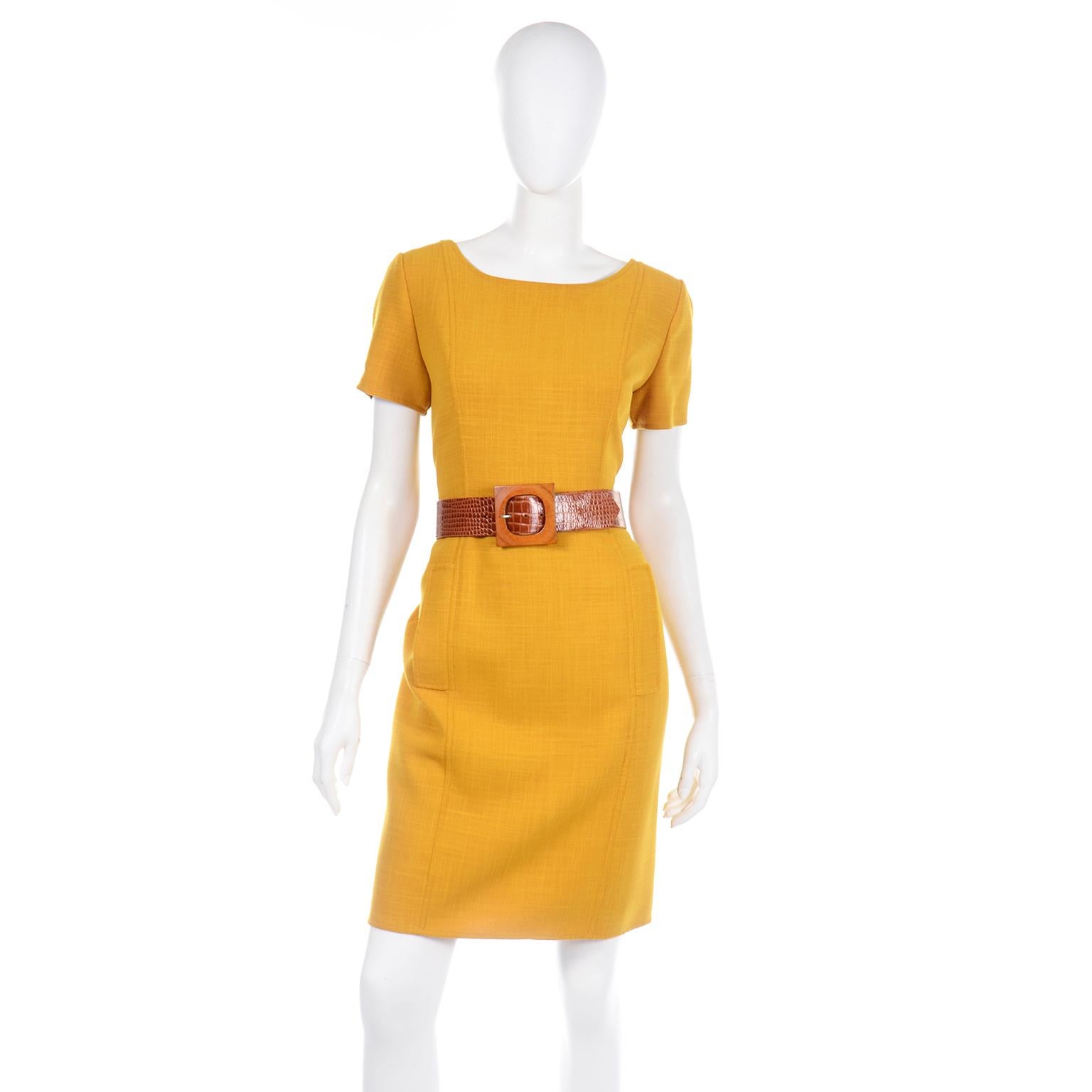 This is a beautiful ensemble from Oscar de la Renta that includes a 100% wool short sleeve dress with a belt and a button front jacket. The fabric is a rich shade of mustard yellow and it is a medium weight, perfect for Fall! The dress has front
