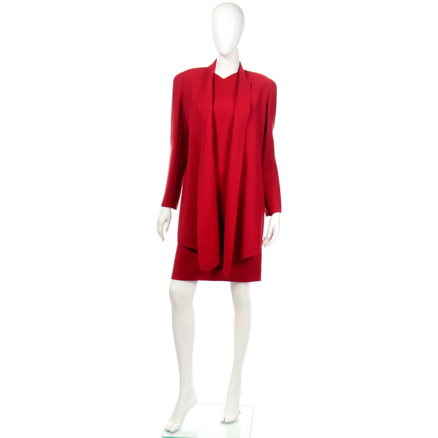 This is a 2 piece vintage Oscar de la Renta dress and jacket suit in a rich red wool blend fabric. This beautiful 2 piece ensemble includes a very flattering sleeveless dress with waist accentuating top stitched seams. The dress closes with a center