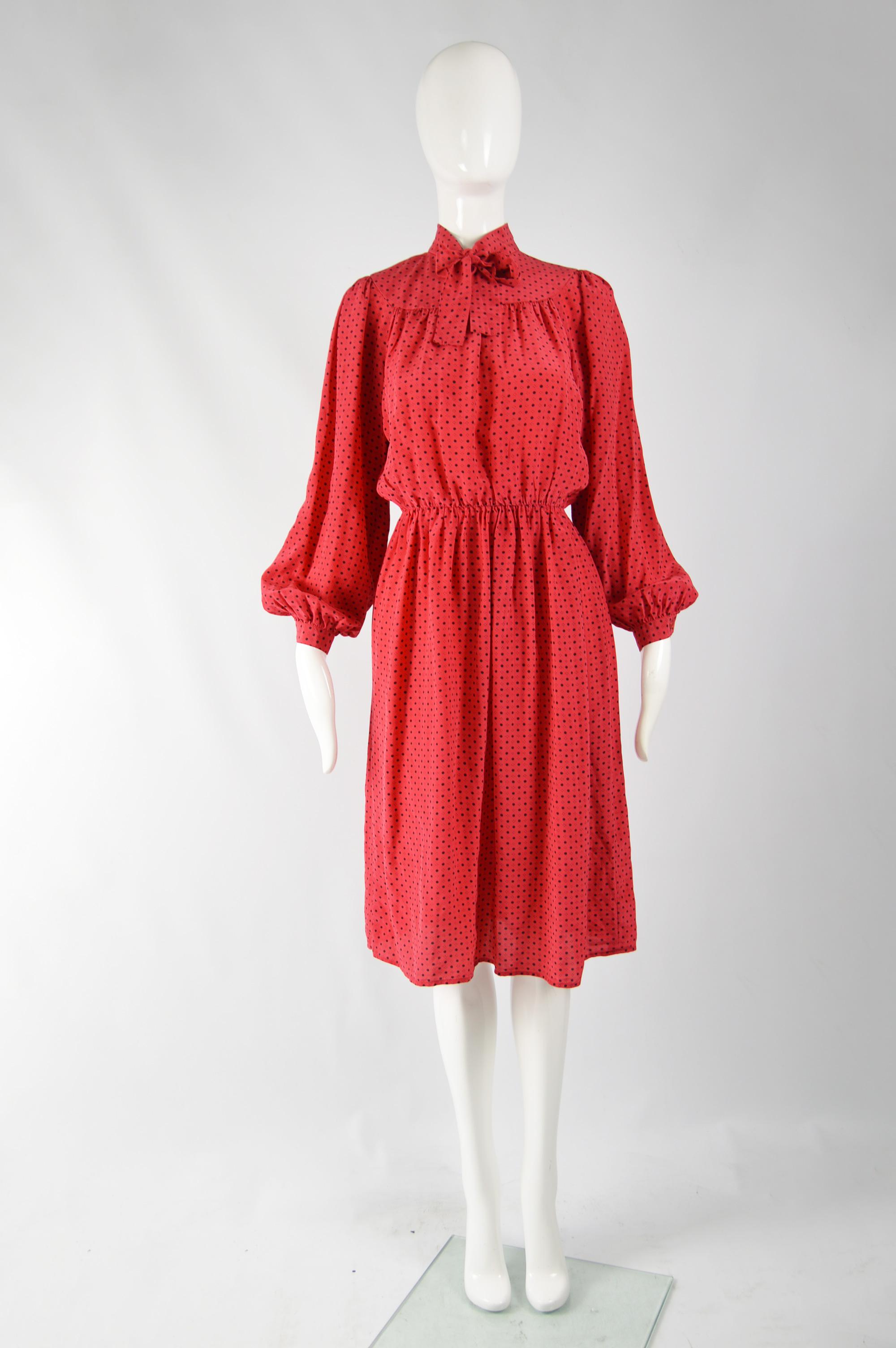 A pretty vintage womens Oscar de la Renta blouson dress from the 80s in a polka dot printed red silk with puff bishop sleeves, a high neck and a pussybow detail. 

Size: fits roughly like a modern women's UK 8/ US 4/ EU 36. Please check