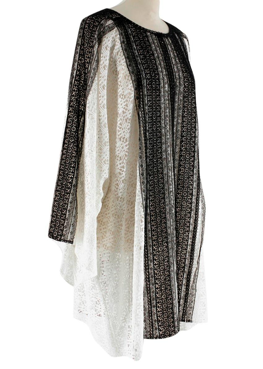 Oscar de la Renta White Black  Lace Dress
- vertical black lace panel down the front
- Round neck with slit detail 
- invisible hook closure around the neck 
- two vertical black lace stripes down the back 
- Long white bat wing sleeves
- Oversize