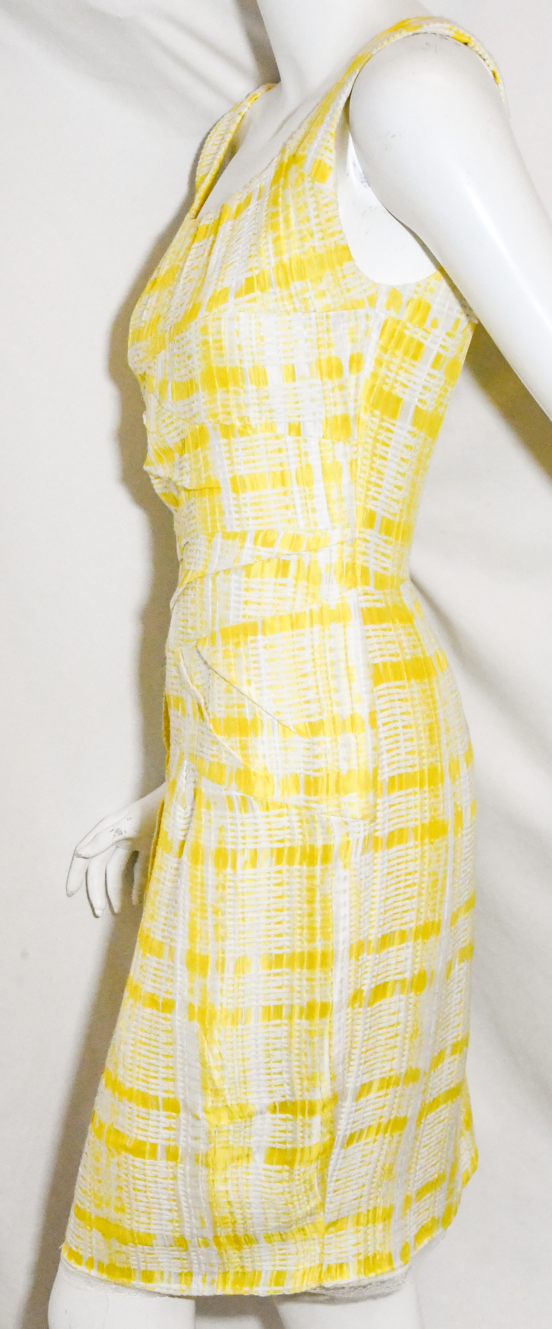 Oscar de la Renta yellow and white check textured fabric includes a scoop neckline and is slightly This dress is elegant yet contemporary.  Dress is lined and is gathered at the neckline and, for closure, includes a long zipper at back with a vent