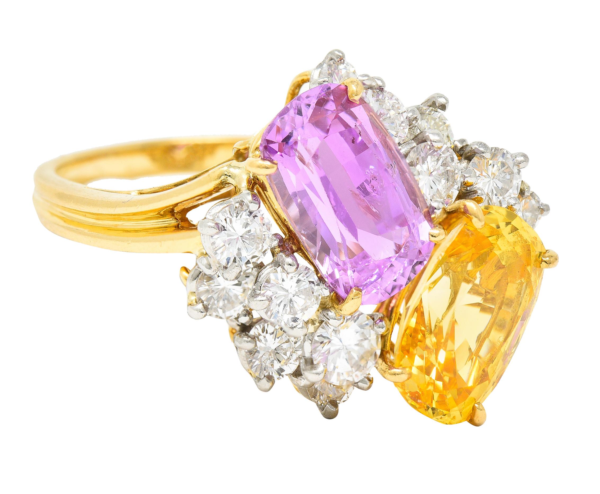 Designed as juxtaposed cushion cut pink and yellow sapphires clustered with round brilliant cut diamonds. Pink sapphire is prong set and weighs approximately 4.15 carats total - light violetish pink. Yellow sapphire is prong set and weighs