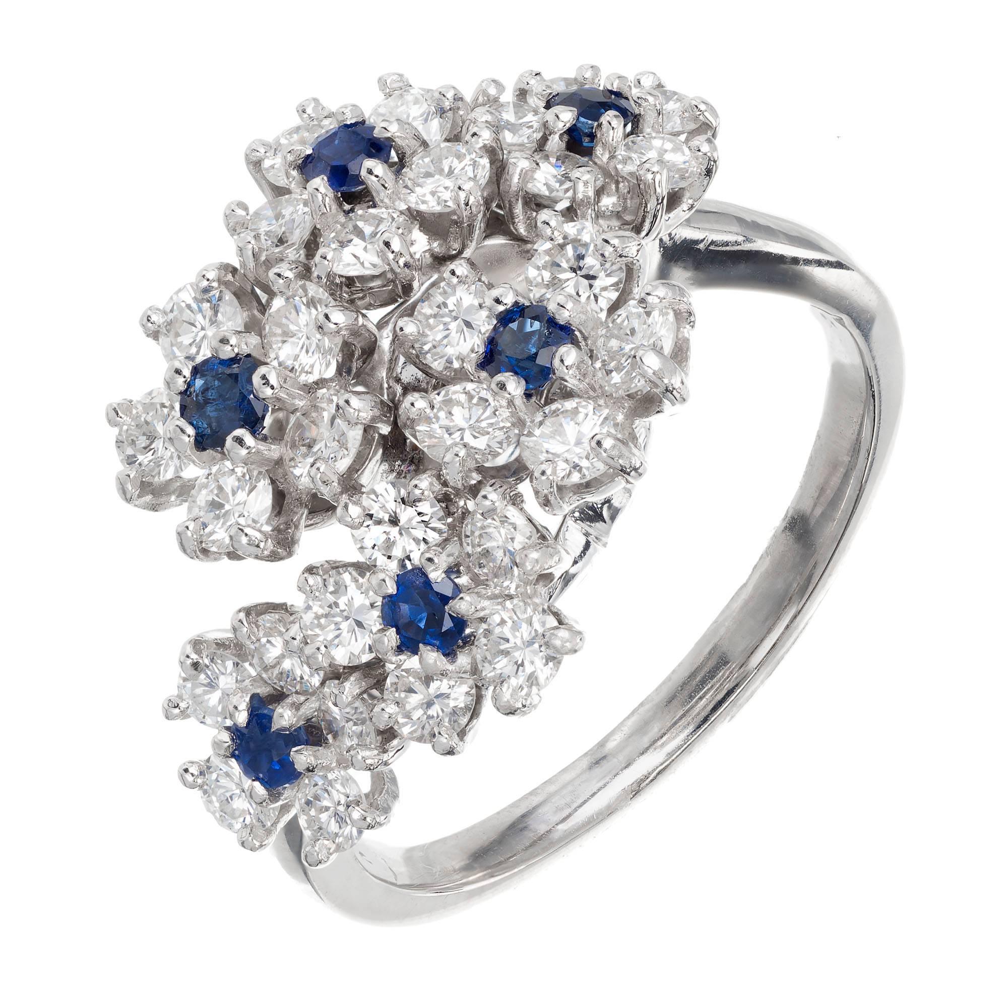 Oscar Heyman bypass platinum diamond sapphire cocktail ring. Six Sapphires with diamond halos in a bypass style design, set in platinum. 

30 round full cut diamonds F to VVS approximate 1.10 carats
6 round bright blue sapphires VS 2mm approximate