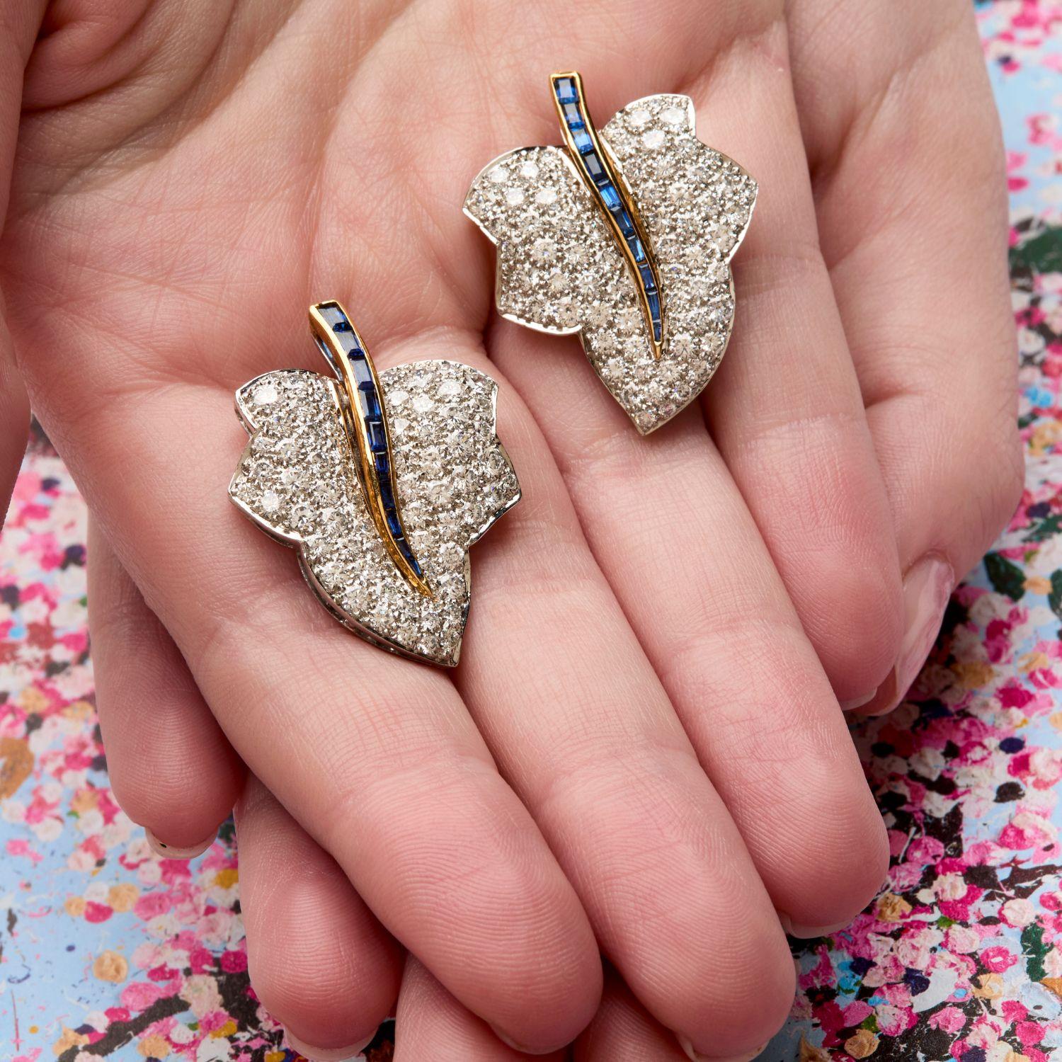 These substantial diamond encrusted leaf-form ear clips are curved the way a real leaf would be but highlight a magical blue sapphire vein up the center of each piece. The blue sapphires are set into 18k yellow gold to make them slightly three