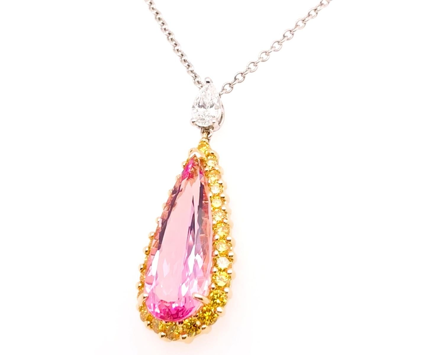Oscar Heyman 18k gold and platinum pendant on a 16'' platinum chain contains 1 Pear Shape Morganite (6.59cts) surrounded by 26 Round Fancy Vivid Yellow Diamonds (1.25cts). Hangs from the chain with a 0.48ct Pear Shape Diamond. It is stamped with the
