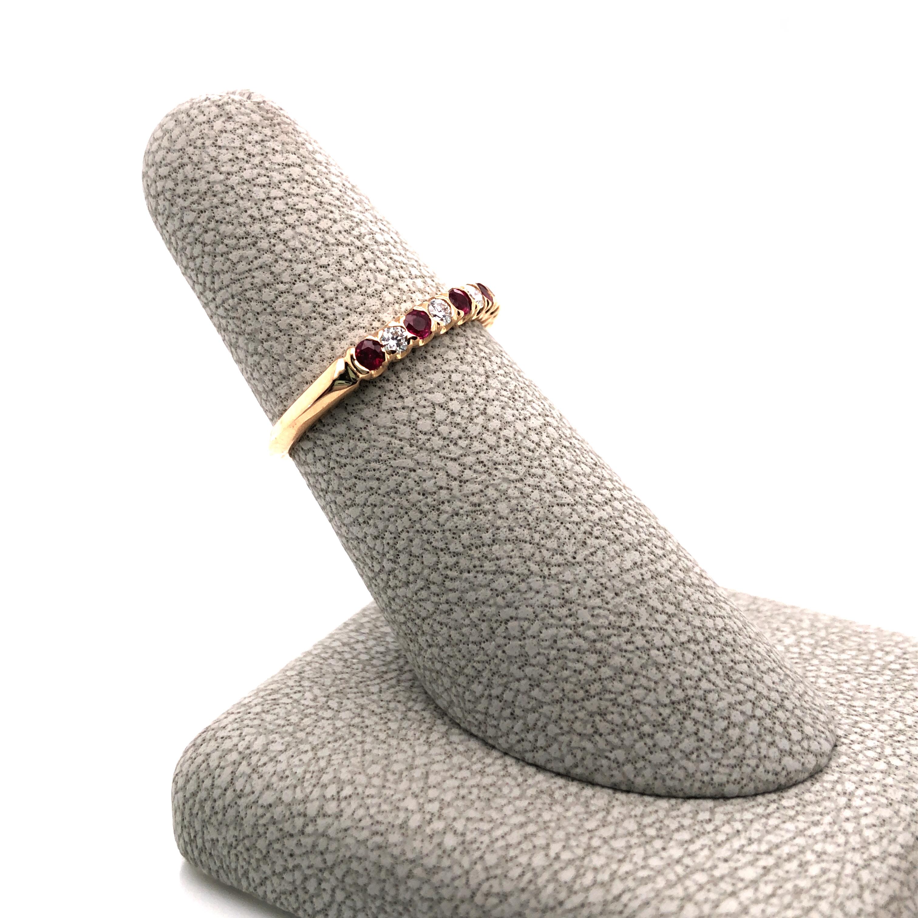 Oscar Heyman 18k yellow gold partway wedding band ring contains 5 round diamonds (F-G/VS, 0.15tcw) and 6 round rubies (0.31tcw). The stones are set in the 'fishtail' style, which is similar to bezel setting with the side metal cut away to expose