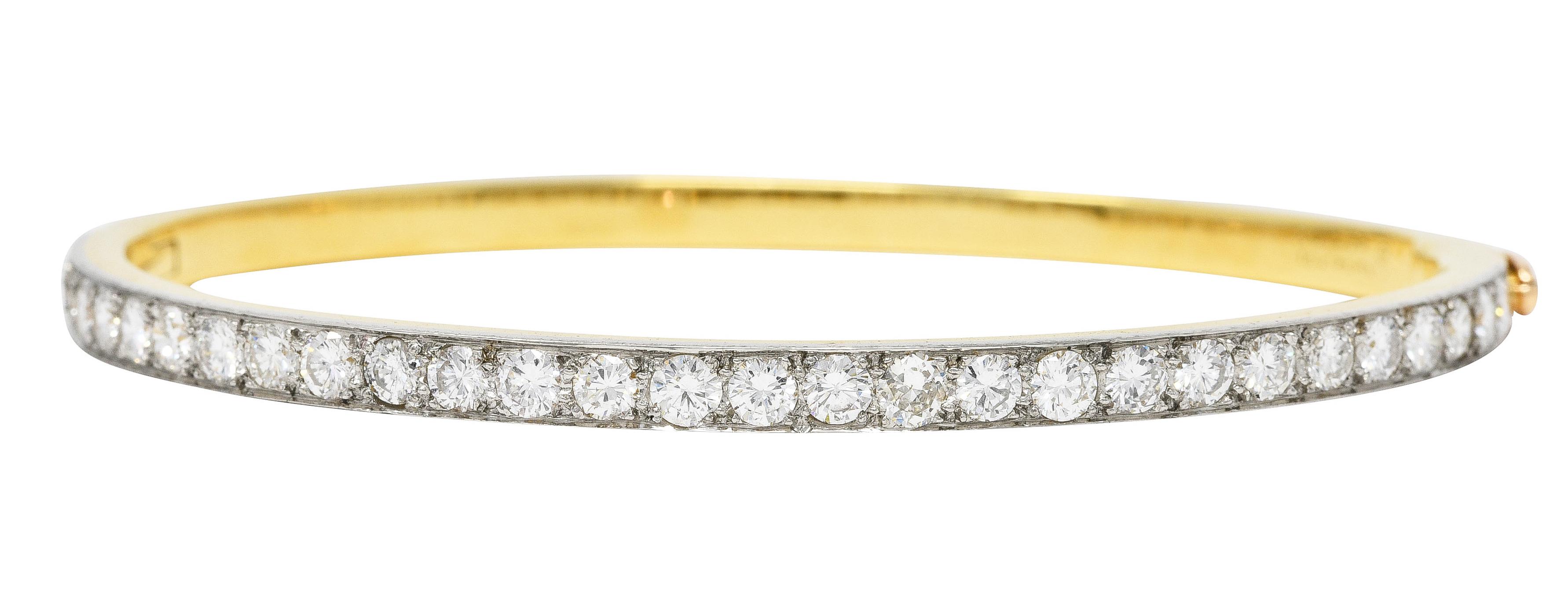 Bracelet features a platinum-topped channel of pavé set transitional cut diamonds. Weighing approximately 2.90 carats total - H to J in color with VS1 to SI1 clarity. Opens on a hinge and is completed by clasp closure with figure eight safety.