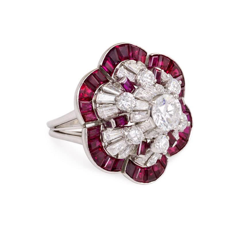 A structured ruby and diamond cocktail ring in the shape of a stylized flower, in platinum. Oscar Heyman Bros. #51494.  Atw rubies 3.72 cts., diamonds 3.56 cts.

Sits approximately 5/8 inch above hand