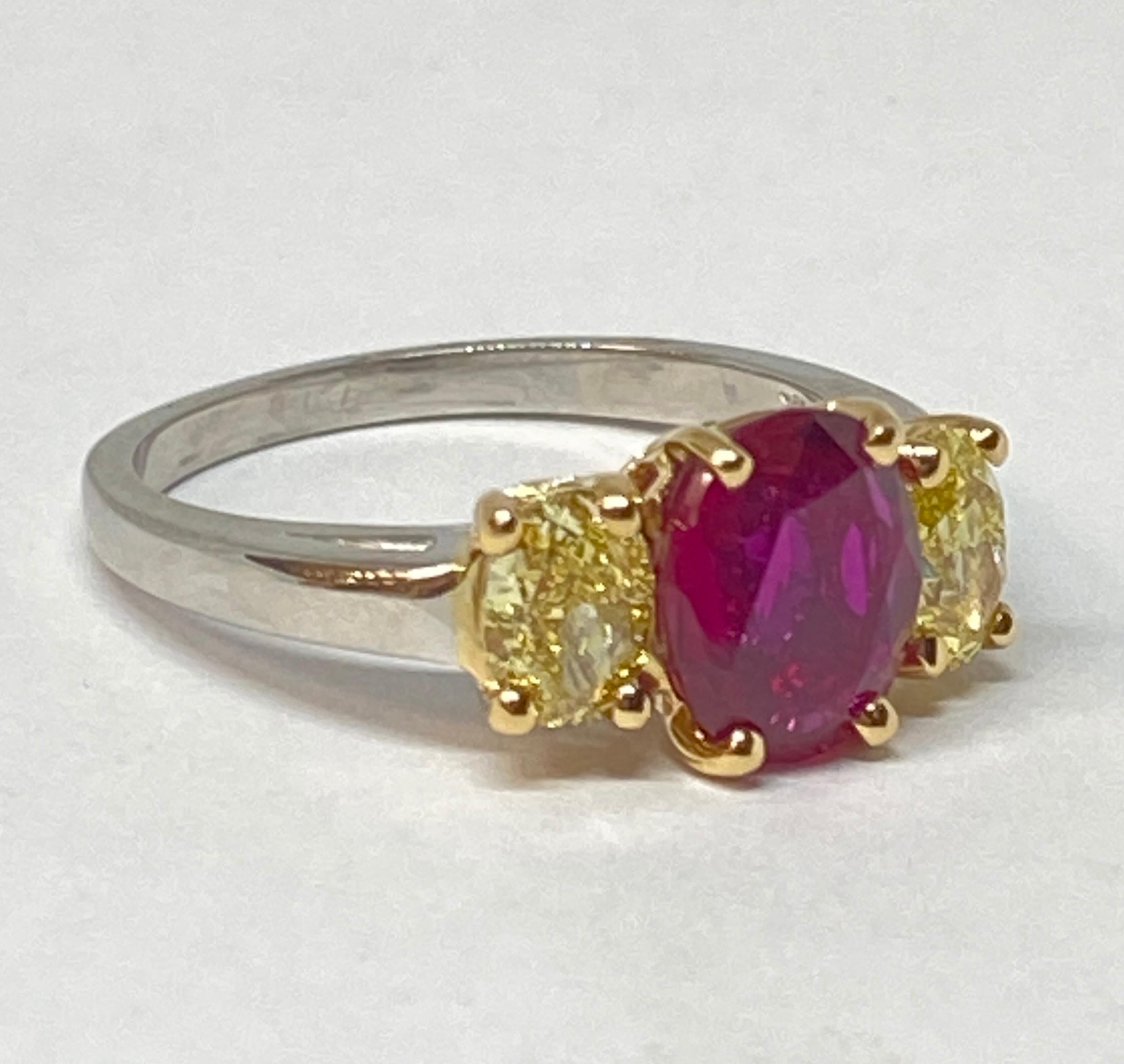 This stunning ruby and diamond three-stone ring designed by Oscar Heyman features a 2.07-carat Burma no-heat oval ruby flanked by two natural yellow oval-shaped diamonds. This ruby is of fine quality and exceptional color.

2.07-carat natural