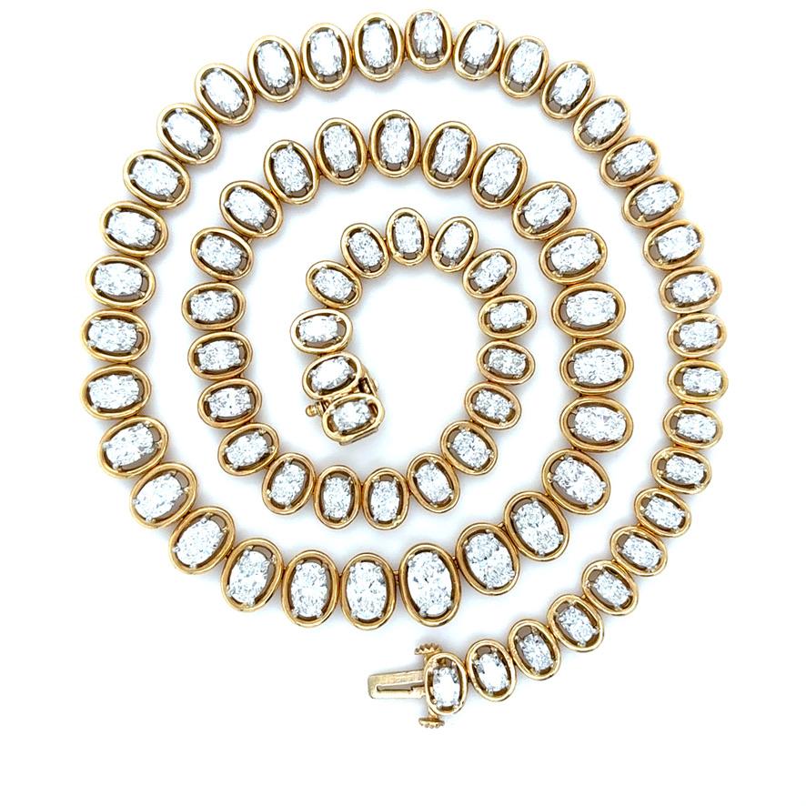 This gorgeous diamond necklace designed by the renowned designer, Oscar Heyman, boasts 72 oval brilliant cut diamonds weighing approximately 22.00 carats total. In a floating 18k yellow gold surround and platinum prongs, this necklace is beautifully