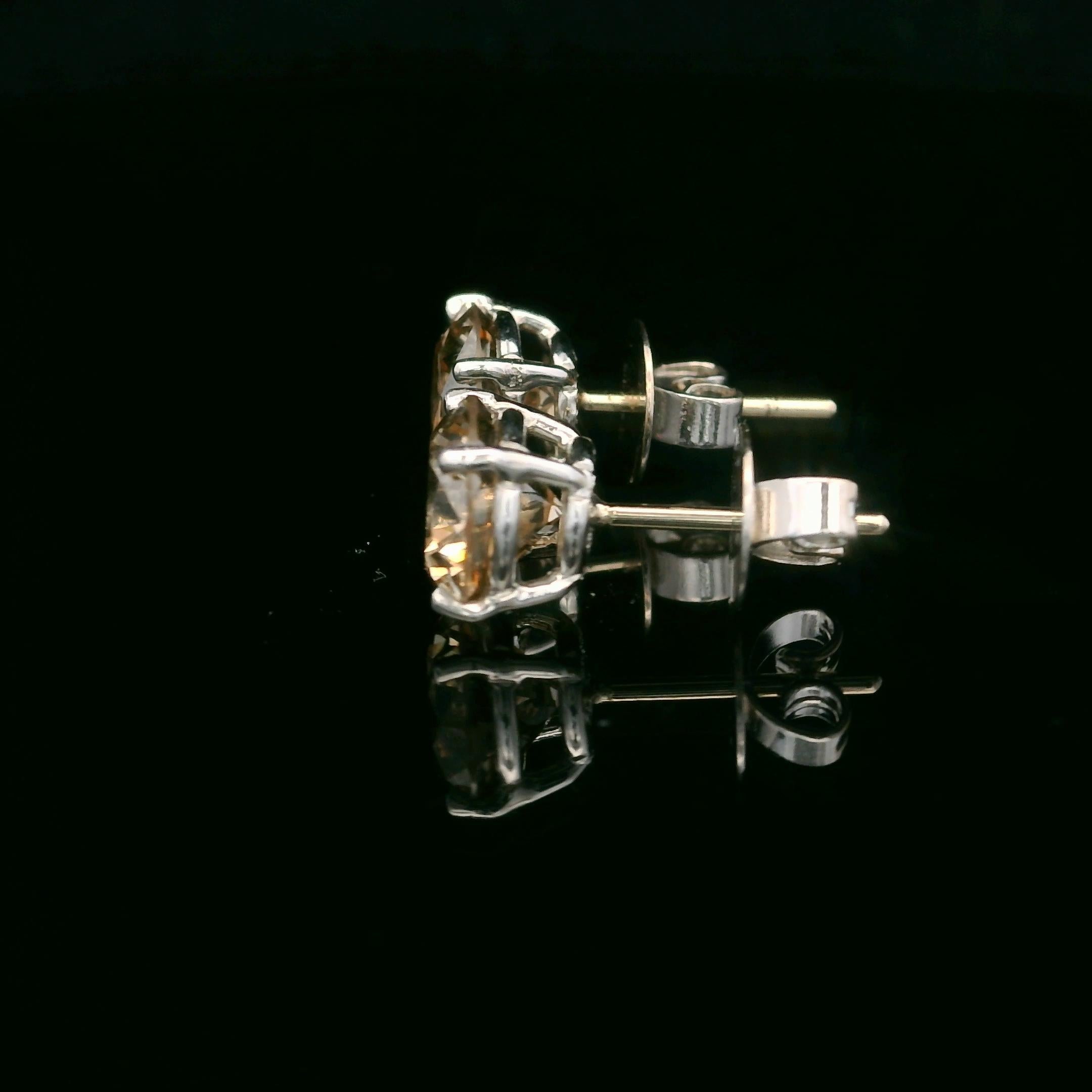 These stunning Oscar Heyman earrings are made from platinum and feature a pair of 'champagne brown' diamonds weighing 3.34tcw (SI1-2). The stones are each 7mm wide and sit in a 4 prong setting. The earrings are an impressive size on the ear. They