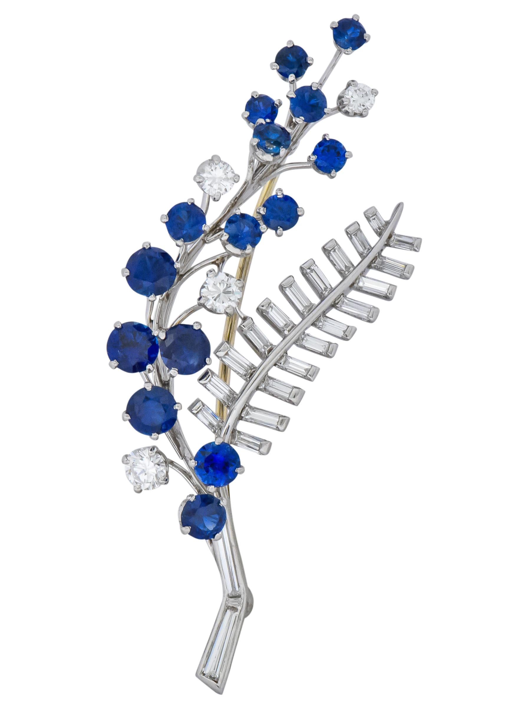 Designed as polished platinum branch set throughout with round cut sapphires weighing approximately 2.50 carats total, transparent and brilliant blue in color

Accented by four round brilliant cut diamonds weighing approximately 0.20 carat total,