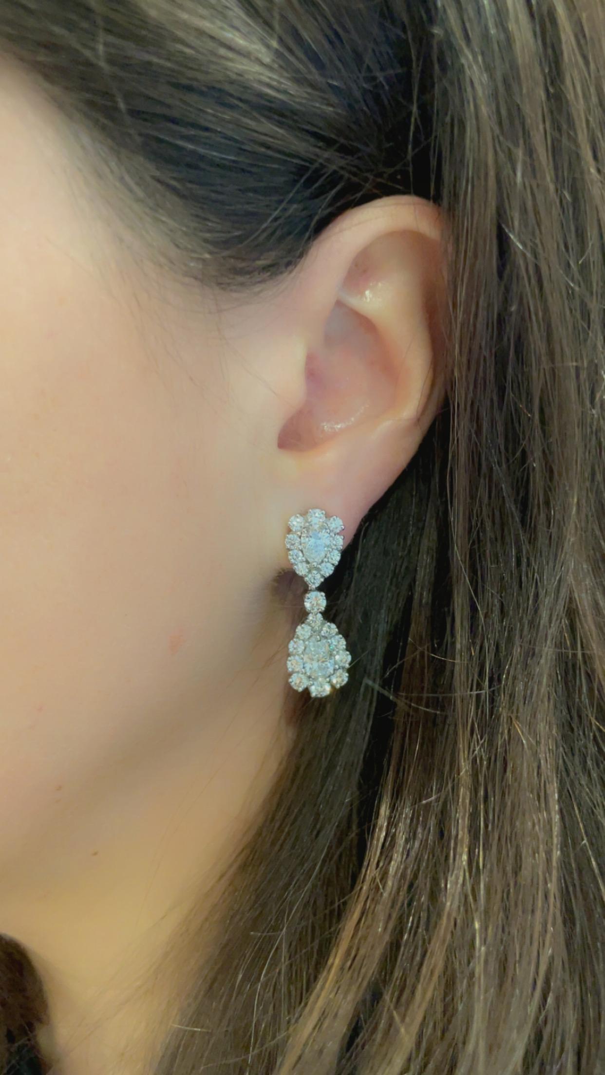 Oscar Heyman diamond drop earrings contain 4 pear shaped diamonds weighing 2.28tcw with 42 round diamonds weighing 2.83tcw surrounding them. The total carat weight is 5.11 cts. All diamonds used are F/G-VS quality. Both earrings are stamped with the
