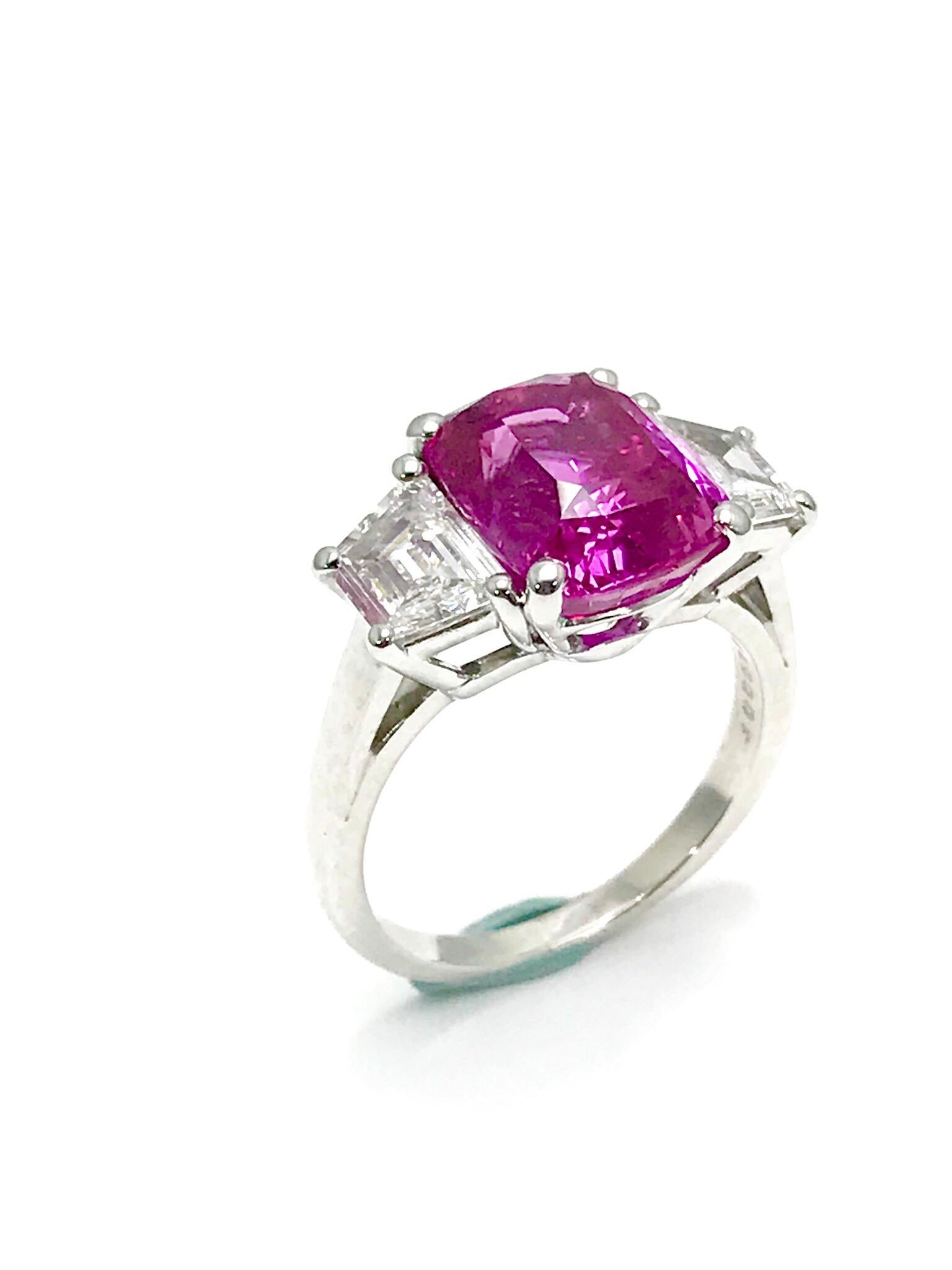 An absolutely stunning Oscar Heyman 6.32 carat Pink Sapphire and trapezoid cut Diamond platinum ring.  The Pink Sapphire displays breathtaking color, set in a four prong basket setting with two trapezoid cut Diamonds on either side.  The Diamonds