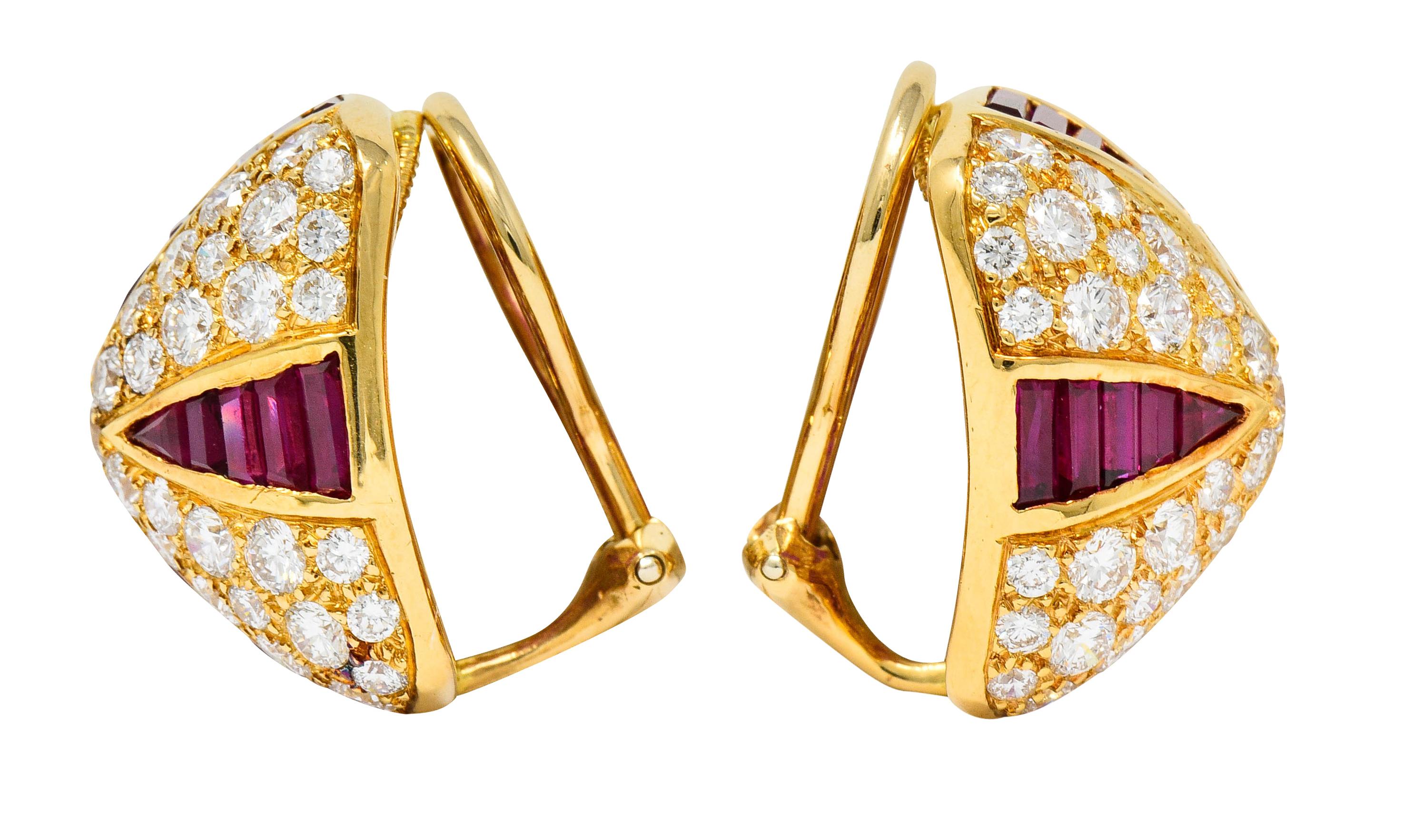 Ear-clips are designed as pyramidal forms

Pavè set throughout by round brilliant cut diamonds weighing in total approximately 4.31 carats; F/G color with VS clarity

Accented by triangular channels of calibrè cut rubies weighing approximately 4.71