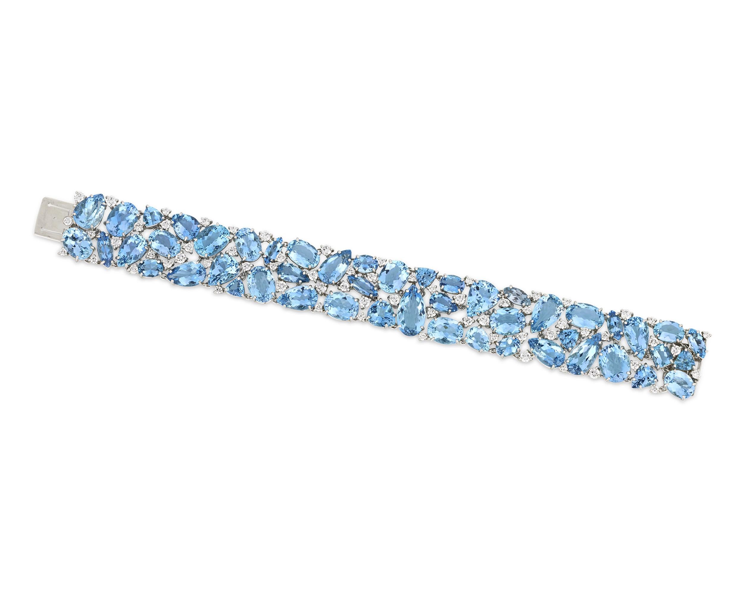 Showcasing a captivating ocean-blue hue, this aquamarine bracelet hails from the famed jeweler Oscar Heyman. Forty-nine aquamarine gemstones form the bracelet, totaling 81.86 carats. The blue jewels are interspersed with sixty-five round diamonds