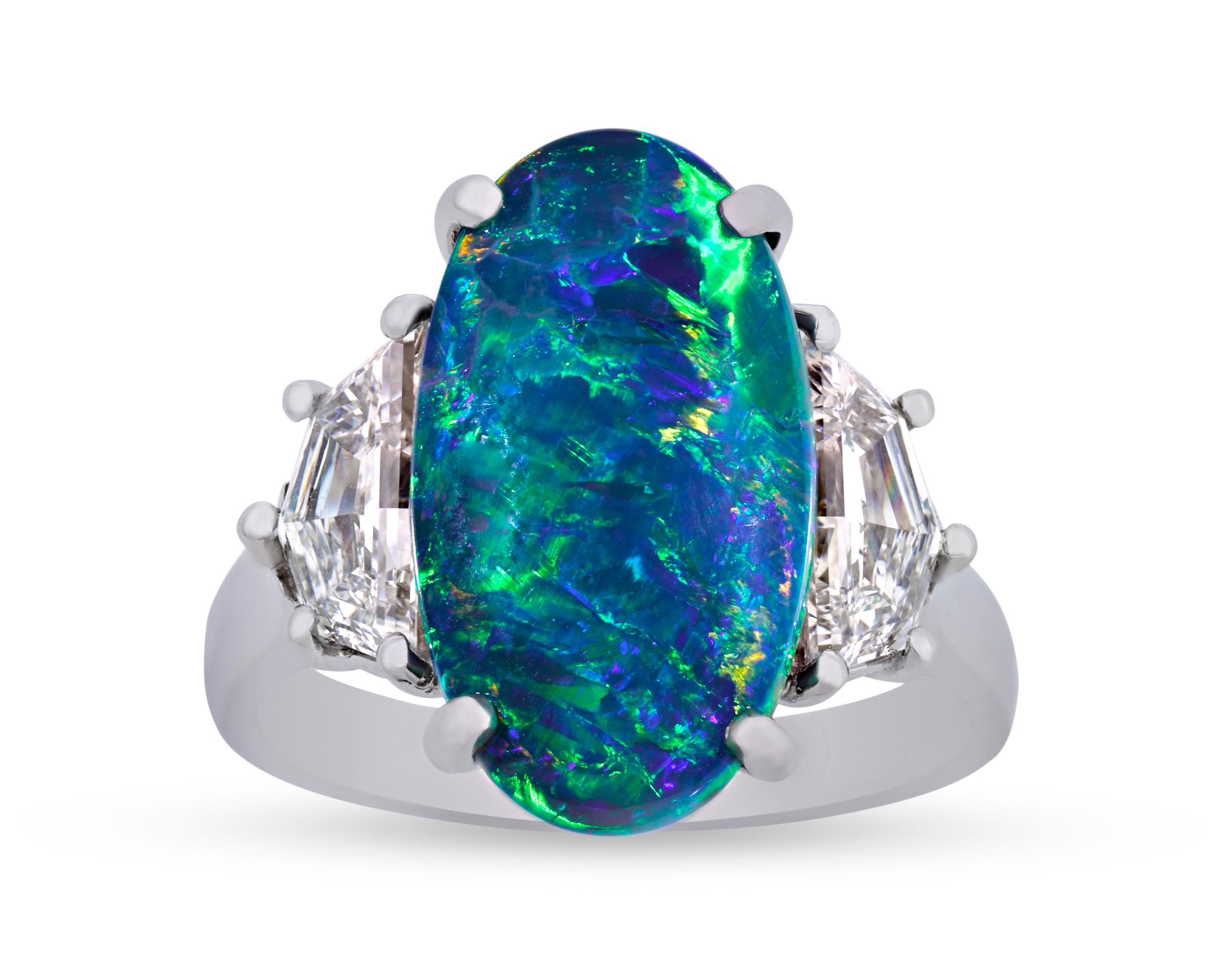 This stunning ring by legendary American jeweler Oscar Heyman features an impressive 4.87-carat oval black opal. Black opals are highly sought after because of their vibrant hues and interplay of colors. With its deep blues and greens, this opal