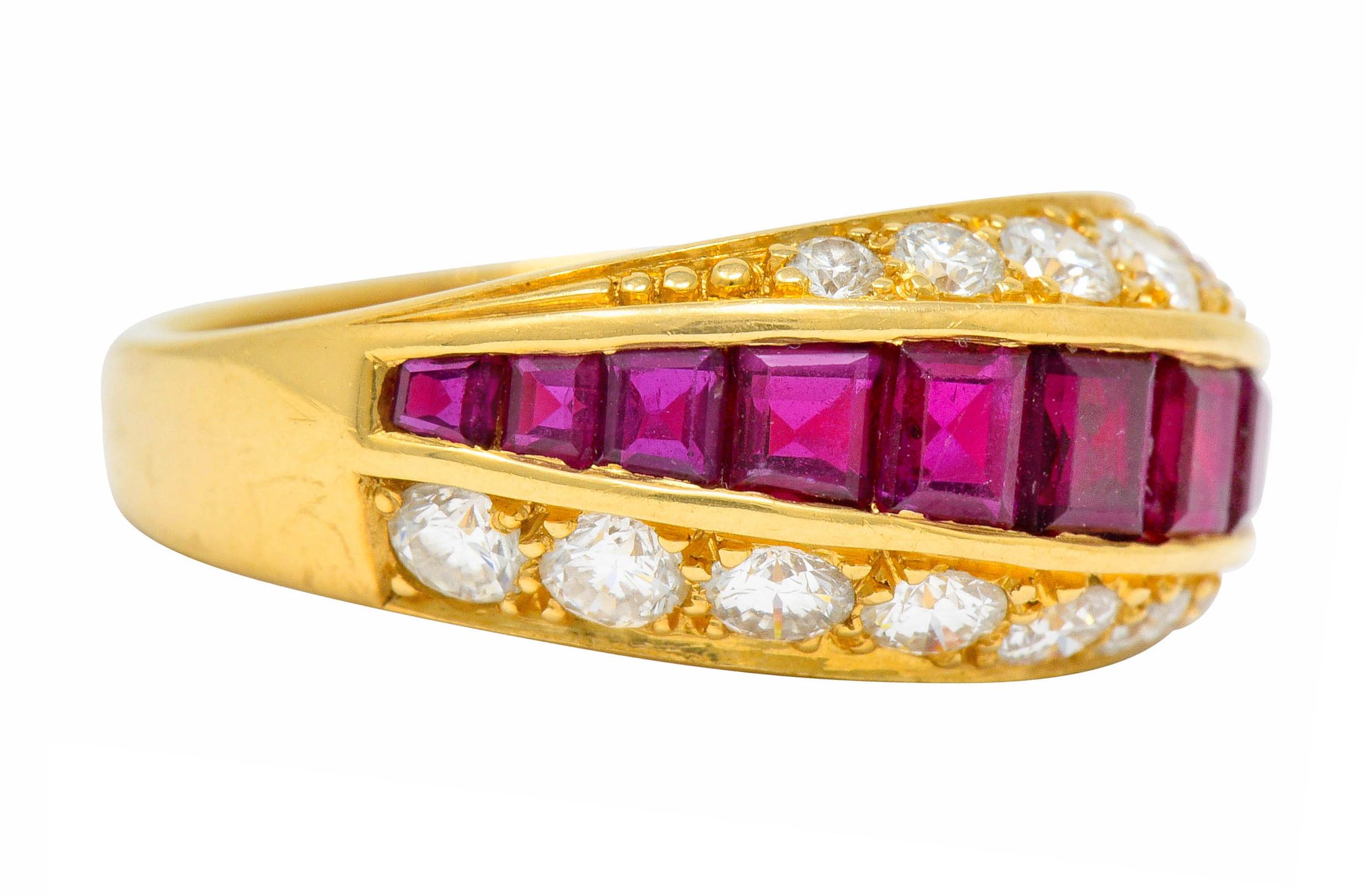 Band ring is designed as three rows of gemstones, slightly torqued

Centering calibrè cut ruby weighing approximately 1.25 carats; slightly purplish-red and very well-matched

Flanked North and South by bead set round brilliant cut diamonds weighing