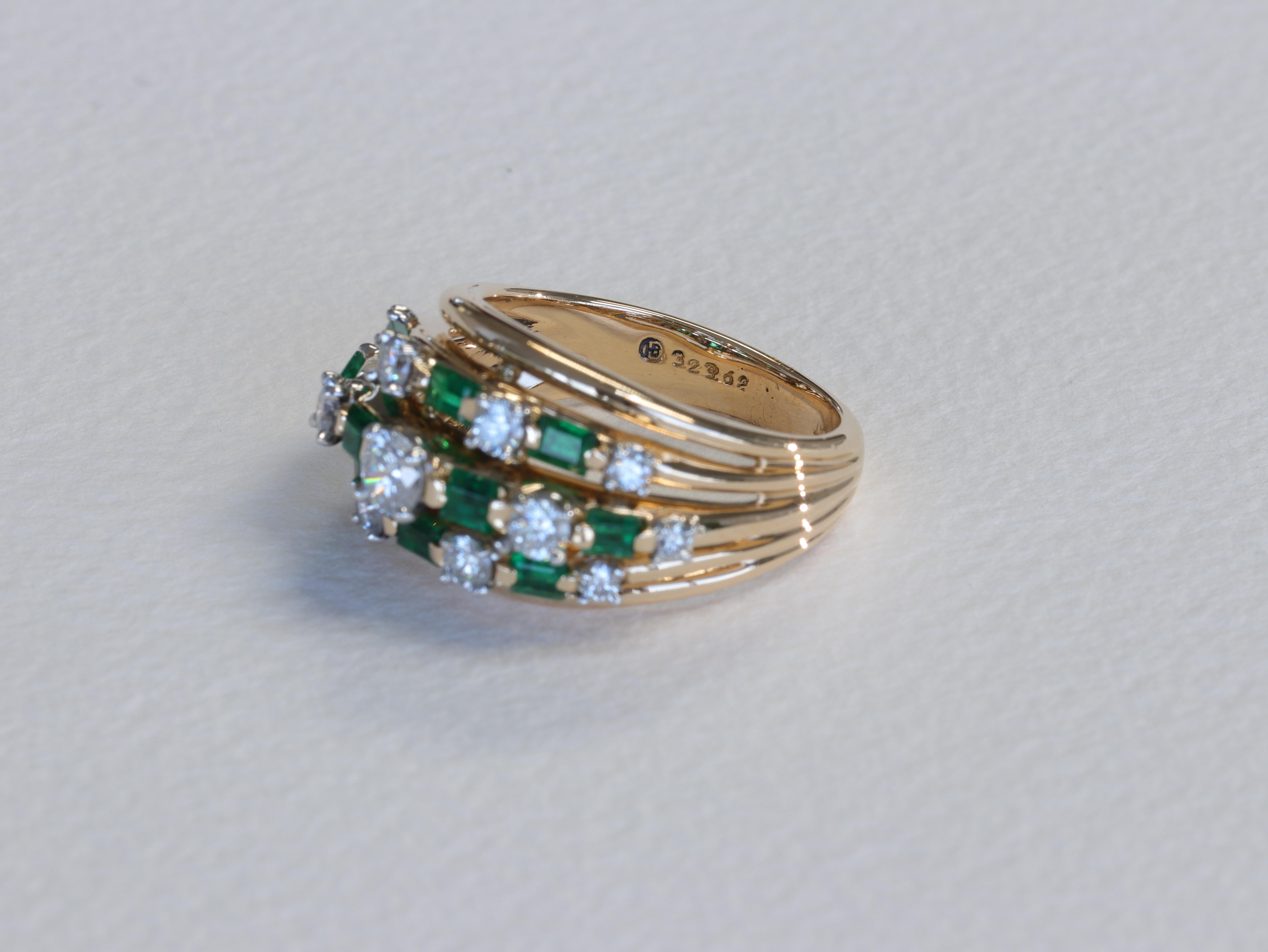 An iconic mid century by Oscar Heyman Bros. this Colombian emerald and diamond ring features approximately 0.80 carats of baguette cut vivid green emerlads and approximately 0.70 carats of round brilliant cut diamonds of D-F color and VVS-VS