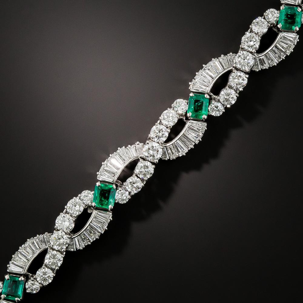 Six glorious rich green Colombian emeralds, together weighing 3.25 carats, glisten and glow between sparkling swirls composed of high-quality icy-white round brilliant-cut and baguette diamonds, together weighing 13.55 carats, in this gorgeous and