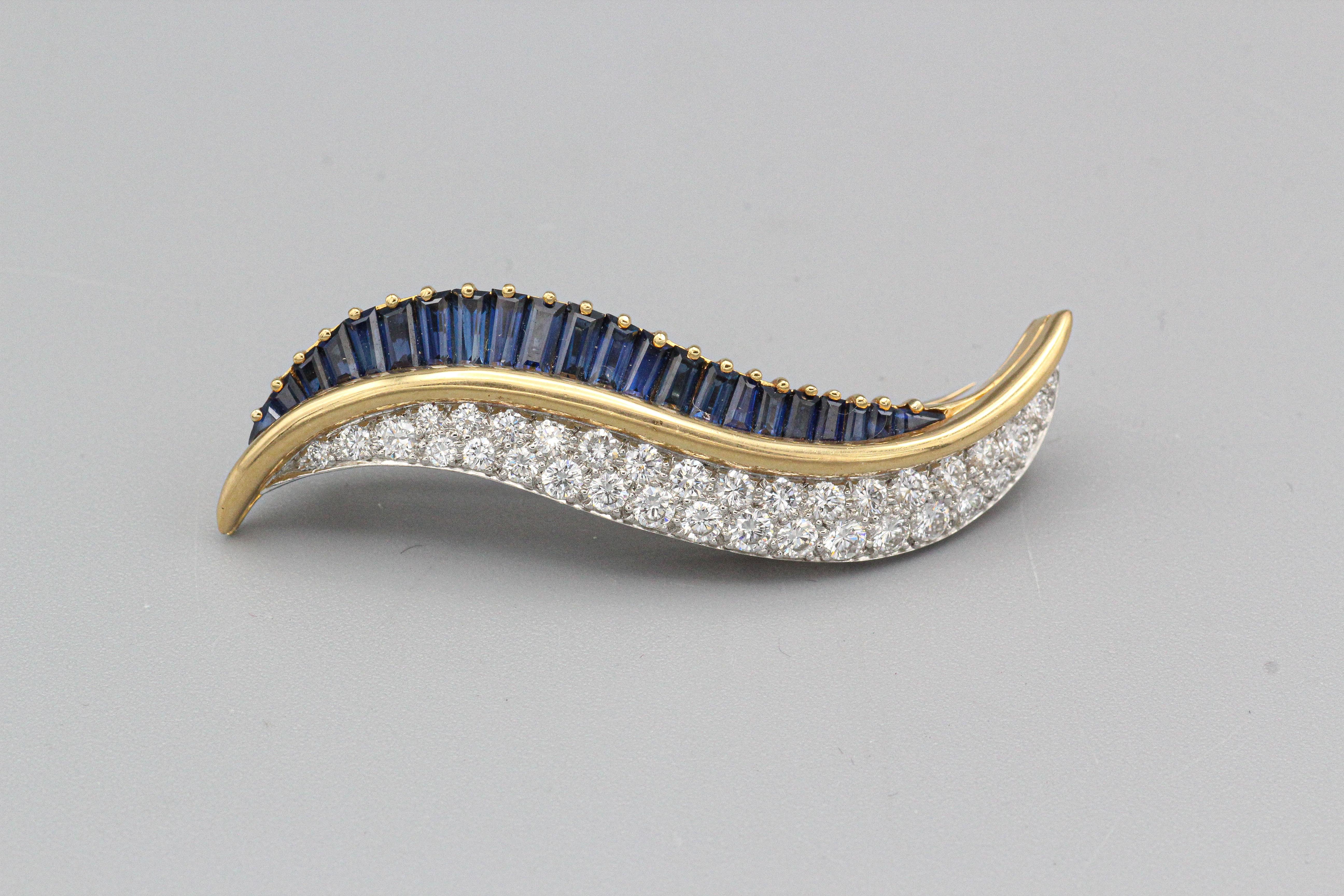 We would like to present this very fine diamond and sapphire brooch by Oscar Heyman & Bros., circa 1980s, for your consideration.

This brooch is a stunning piece of jewelry crafted with exquisite attention to detail. Made from 18k gold and