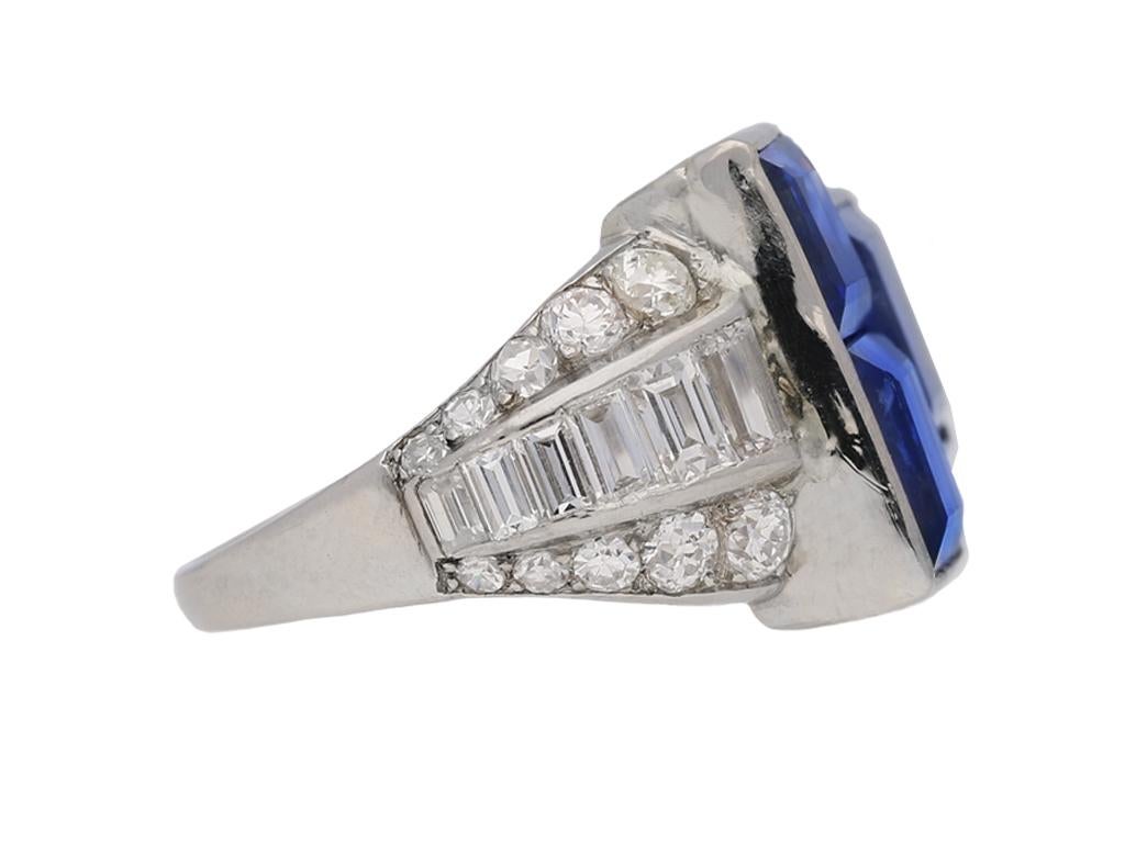 Art Deco sapphire and diamond ring by Oscar Heyman Brothers. Set to centre with three square step cut natural unenhanced Ceylon sapphires in open back rubover channel settings with an approximate combined weight of 9.50 carats, the shoulders set