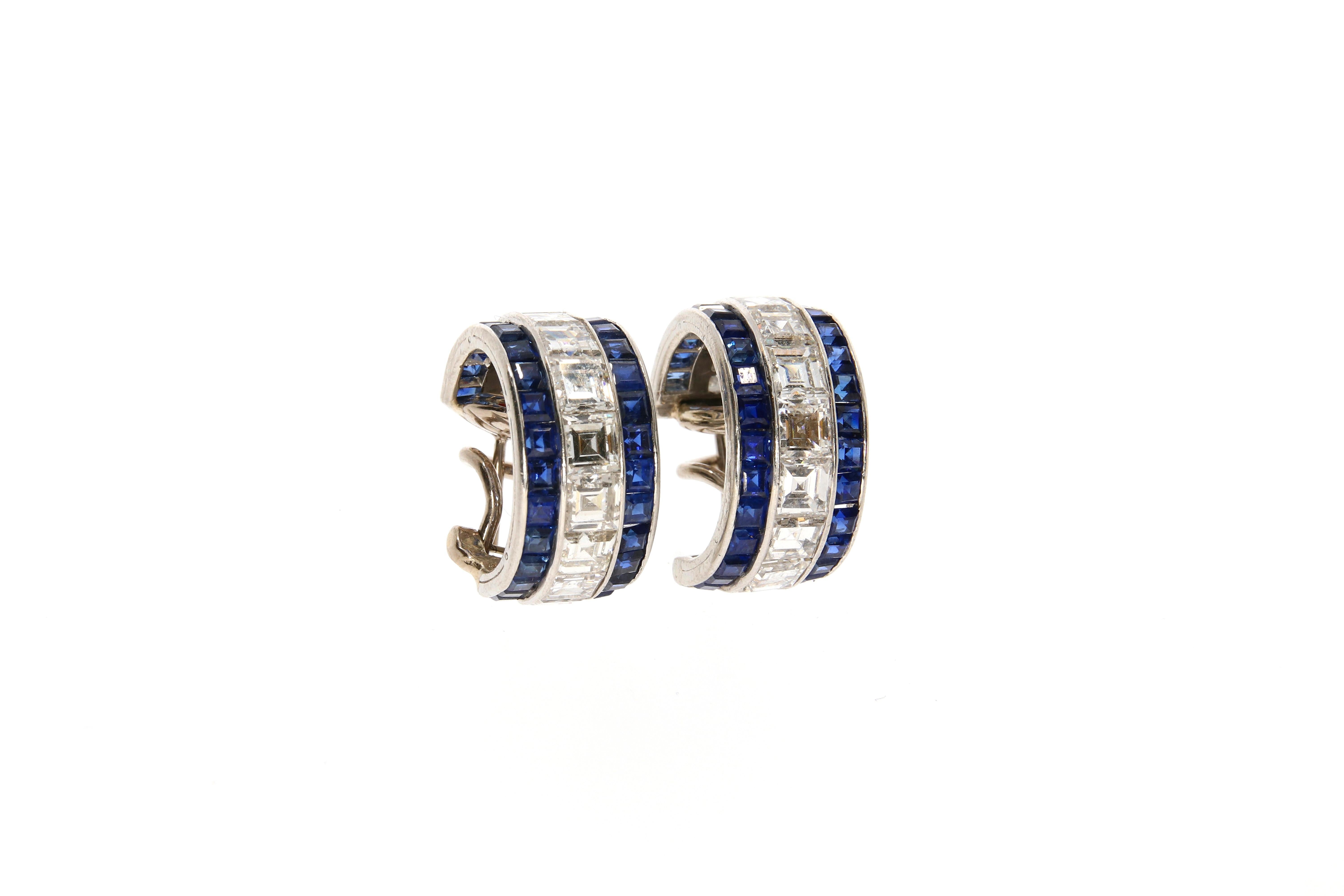 An exquisite pair of little platinum hoops, by Oscar Heyman and Brothers. 
Each designed as a slightly graduated line of 11 carré diamonds (in total approx.: 3 ct) between two lines of 34 blue sapphire carrés (in total approx.: 1.35 ct ). 
Assigned