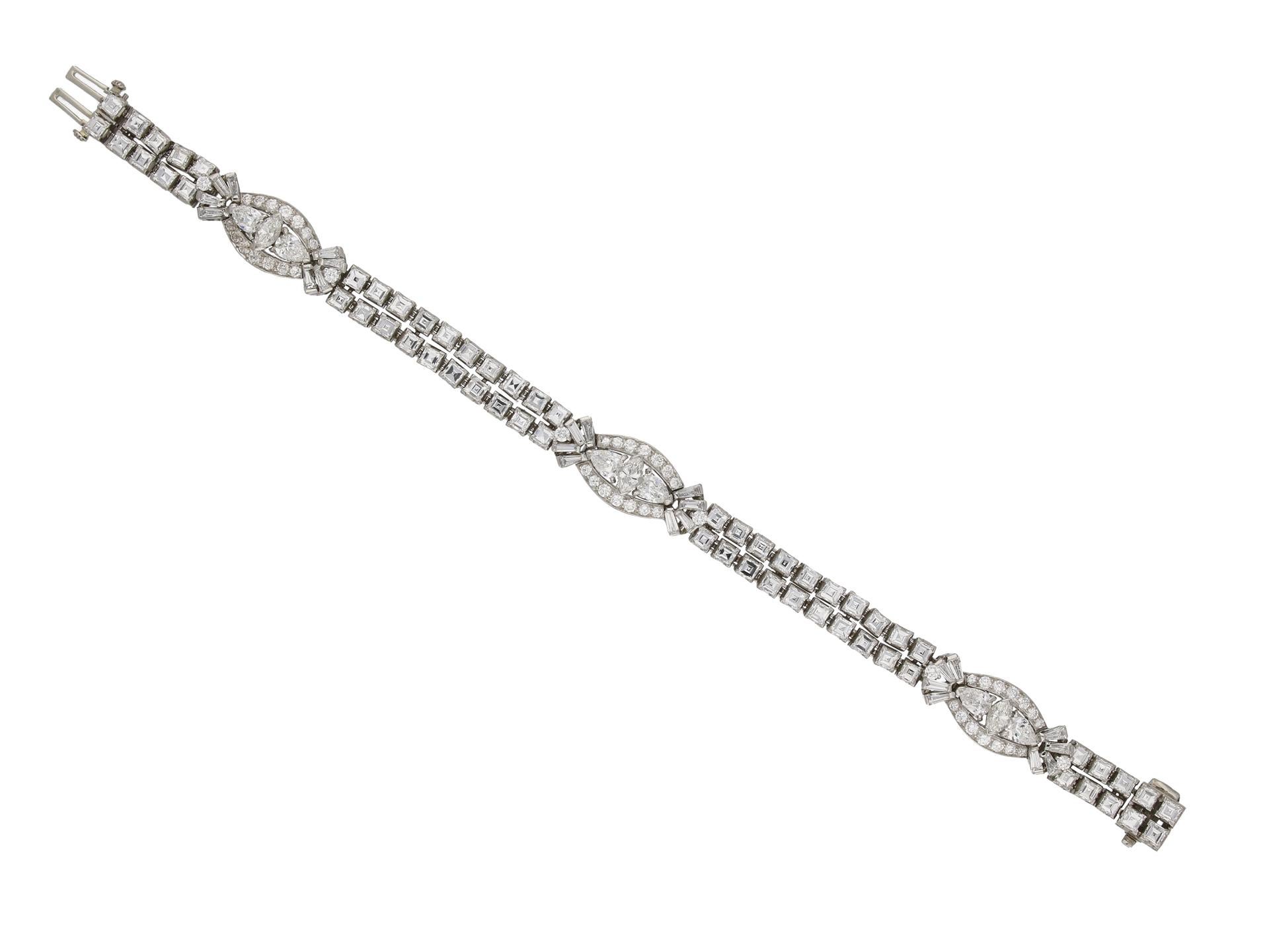 Diamond bracelet by Oscar Heyman Brothers. An articulated two row bracelet set with three motifs of a vertically set marquise shape brilliant cut diamond in an open back claw setting, all three with a combined weight of 0.75 carats, flanked by two
