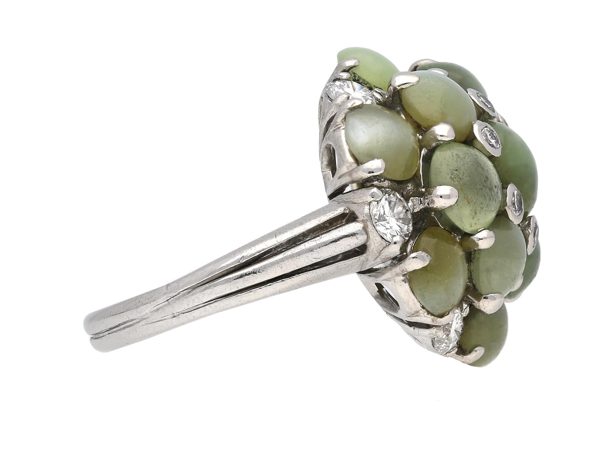 Oscar Heyman Brothers cat's eye chrysoberyl and diamond ring. Set with thirteen round cabochon cat’s eye chrysoberyls in open back claw settings with an approximate combined weight of 10.00 carats, further set with a central ring of six round