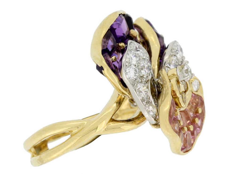 Oscar Heyman Brothers pansy ring. Set with eighteen channel set calibre step cut natural unenhanced amethysts in open back grain and rubover settings with an approximate combined weight of 2.87 carats to two petal shapes, with nineteen round