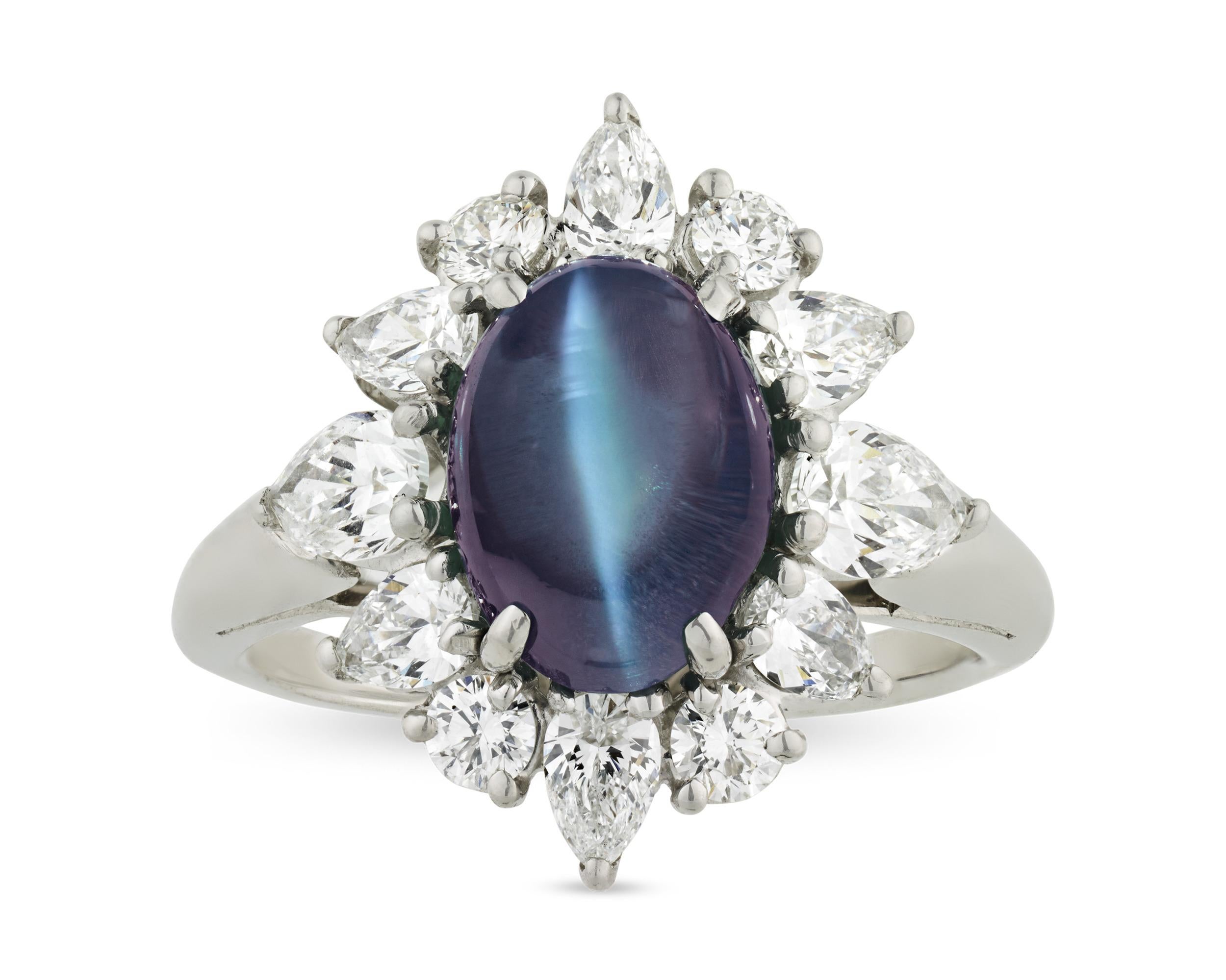 Weighing 3.65 carats, the captivating cat's eye alexandrite in this Oscar Heyman creation exhibits the unique color change for which these rare stones are legendary. The cabochon stone displays a lovely bluish yellowish green hue in daylight and a