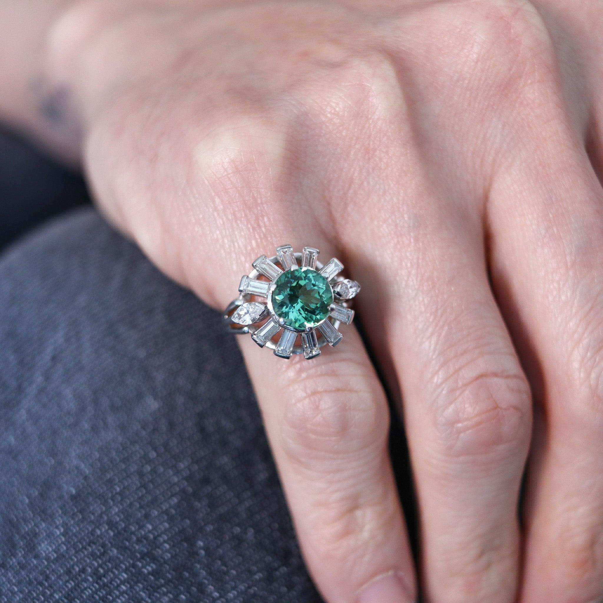 Cocktail ring designed by the Oscar Heyman Brothers.

This is an outstanding cluster cocktail ring, created in New York city by the iconic jewelry makers of Oscar Heyman Company. The fabulous ring has been masterfully crafted in solid .900/.999