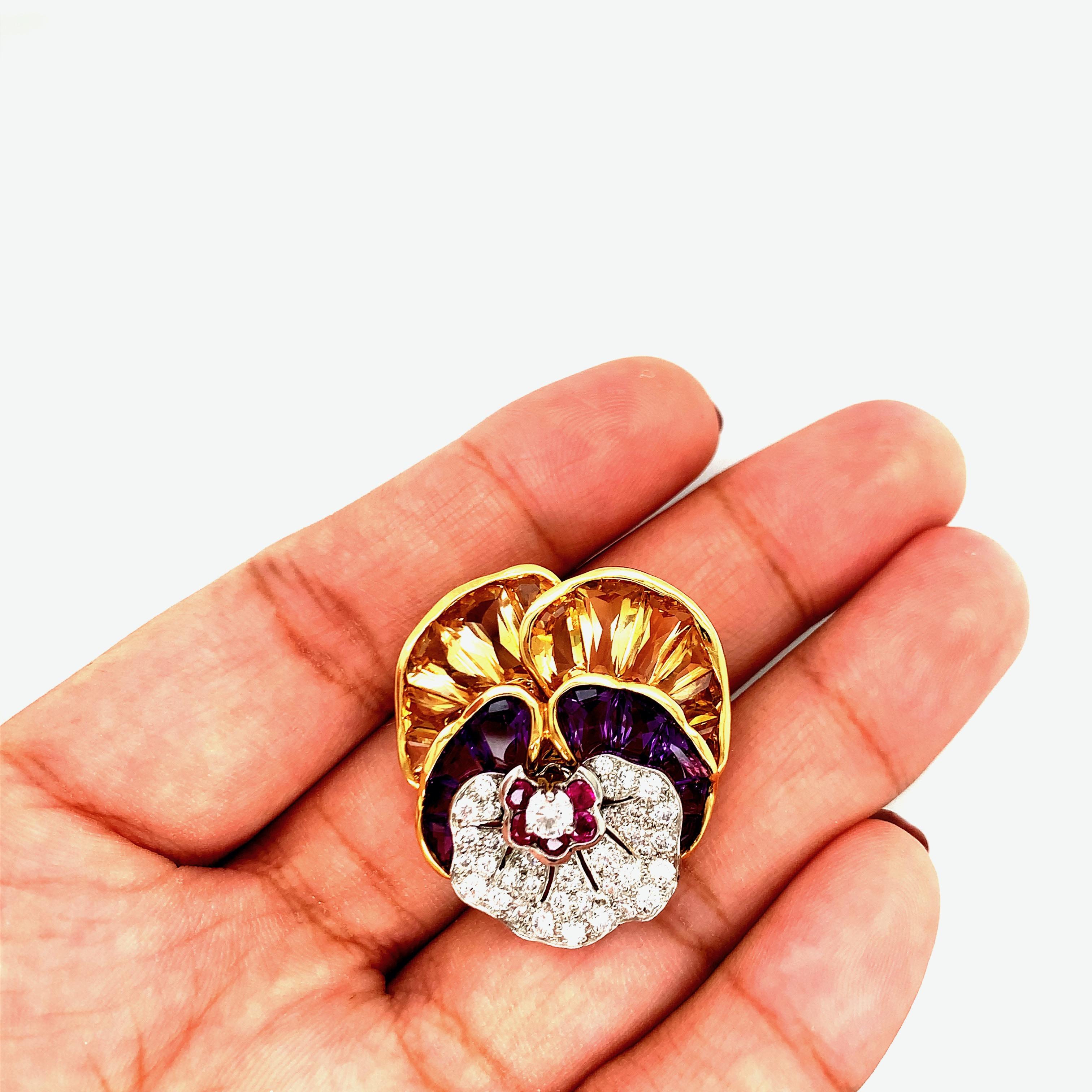 Iconic Oscar Heyman platinum and 18k gold pansy flower brooch, set with amethyst, citrine, rubies and approx. 1.25ctw G/VS diamonds. The brooch measures 1.25