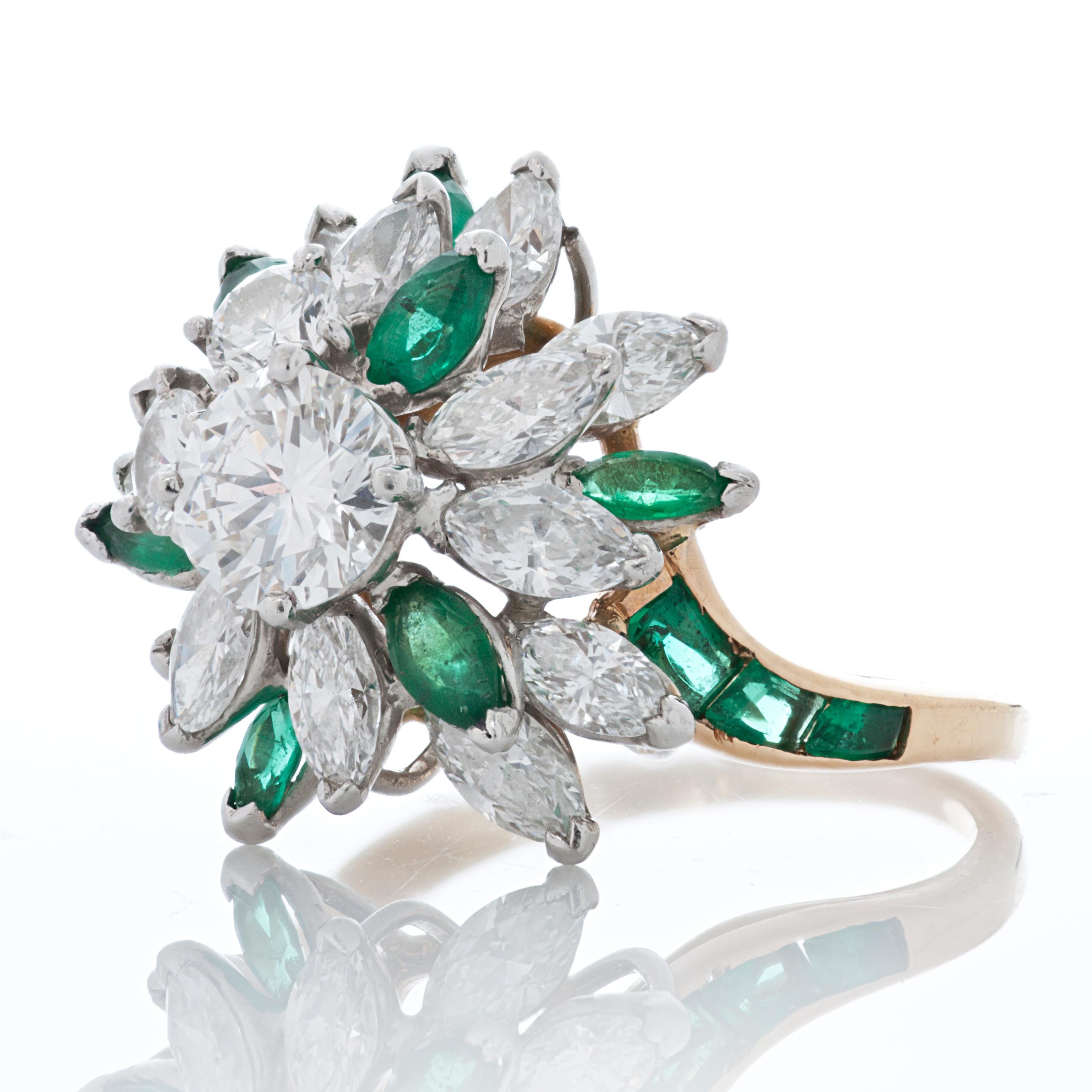 Oscar Heyman diamond and emerald 18k yellow gold cocktail cluster style ring.  

The centerpiece of this ring is a 0.70 carat round diamond surrounded by 2 round diamonds totaling 0.30 carat and 13 marquise cut diamonds totaling 1.50ct.  The