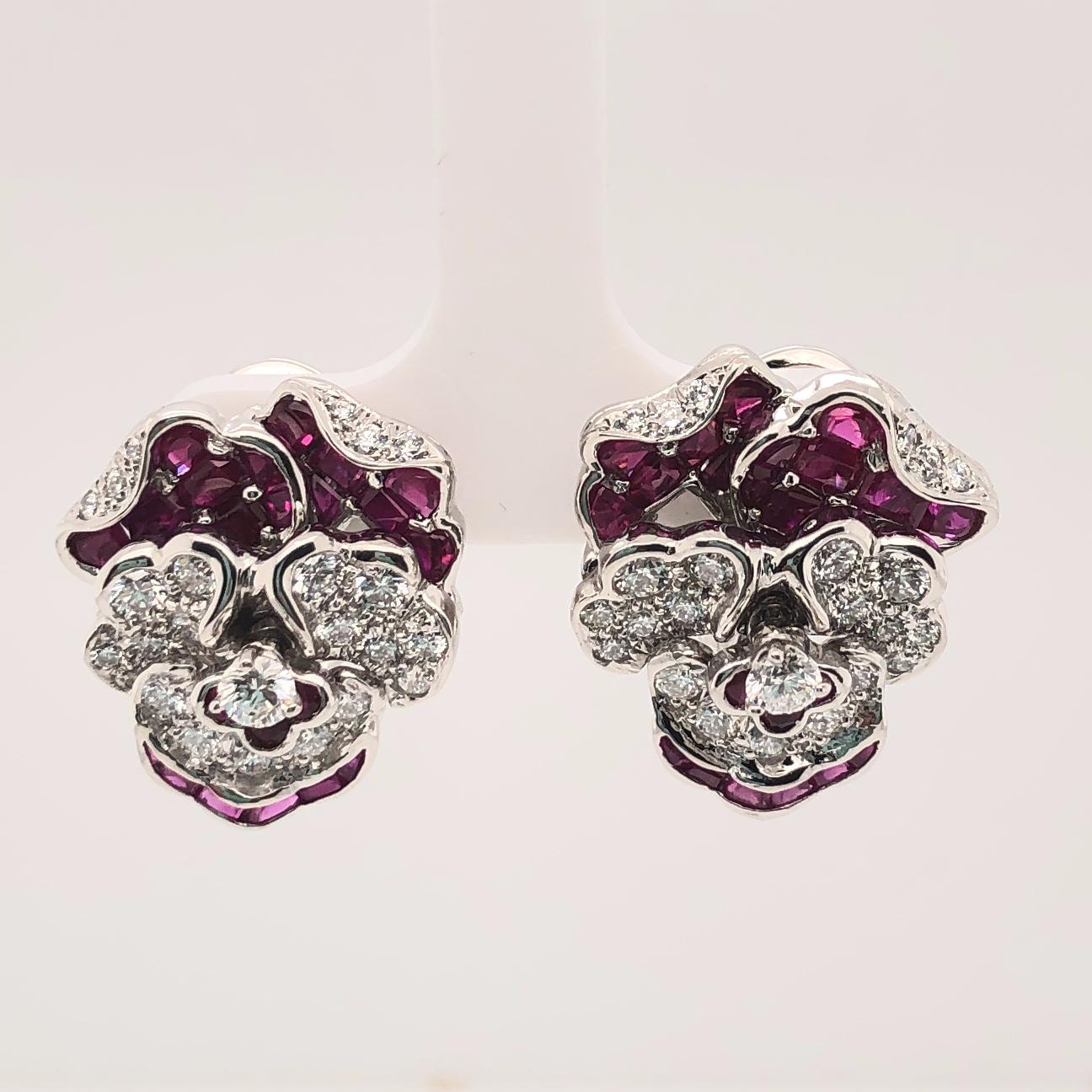 Oscar Heyman platinum pansy earrings contain 26 square rubies (3.77cts), 12 baguette rubies (0.38cts), 6 round rubies (0.2cts) and 48 round diamonds (1.61cts). It is stamped with the makers mark, IRID PLAT, and serial number 706346.

Earrings
