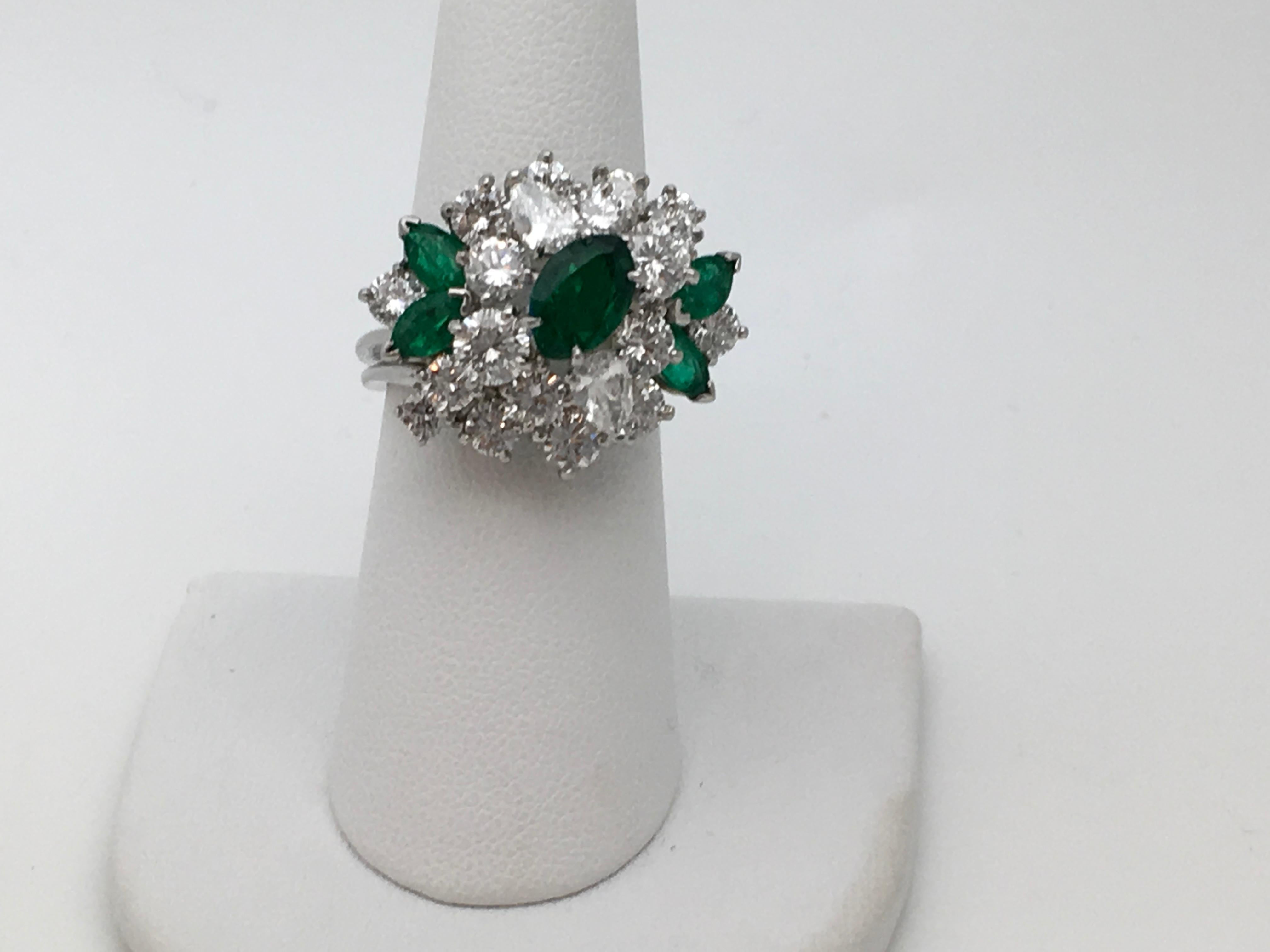 Oscar Heyman Diamond Emerald Platinum Ring, “92871” stamped in shank. 
There are 19 diamonds , 2 pear shape and 17 Round Brilliant Cut Diamonds for 4+ Carats by measure. The Diamond quality; Color E-F, Clarity VVS. The make is very good.
There are 5