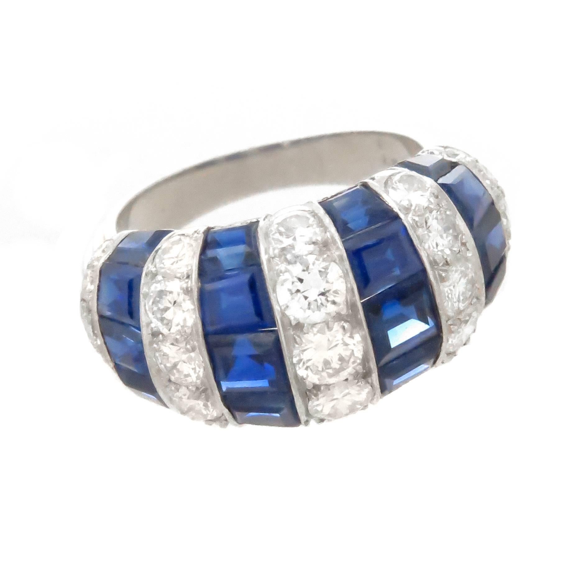 Circa 1990 Oscar Heyman & Brothers Platinum Ring, set with Round Brilliant cut Diamonds totaling 1 carat and Square cut Sapphires totaling 1 Carat. The top of the ring measures 3/4 inch in length and 3/8 inch wide. Finger size = 4