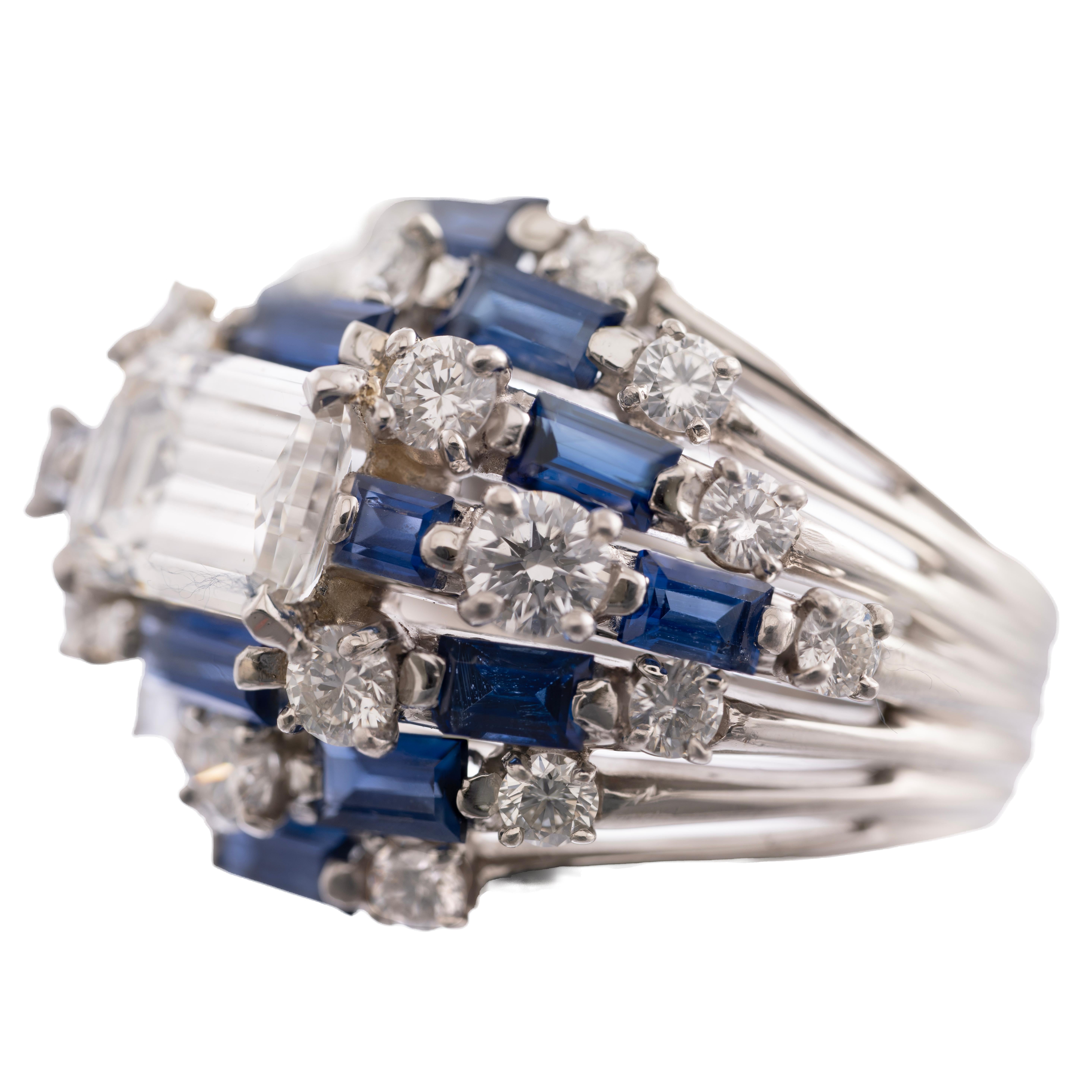 An incredible vintage diamond and sapphire ring by historic jewelry house Oscar Heyman. Featuring a 2.04 carat Emerald Cut Diamond with a GIA certificate stating  F color VS1 clarity, this ring is adorned with an additional 3.25 carats of round