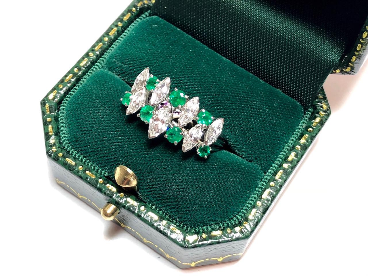 An emerald and diamond ring by Oscar Heyman, with two rows of alternating marquise-cut diamonds and round faceted emeralds. Mounted in Platinum. Signed and numbered. Estimated total diamond weight 1.20ct.

Finger size UK M / US 6.
