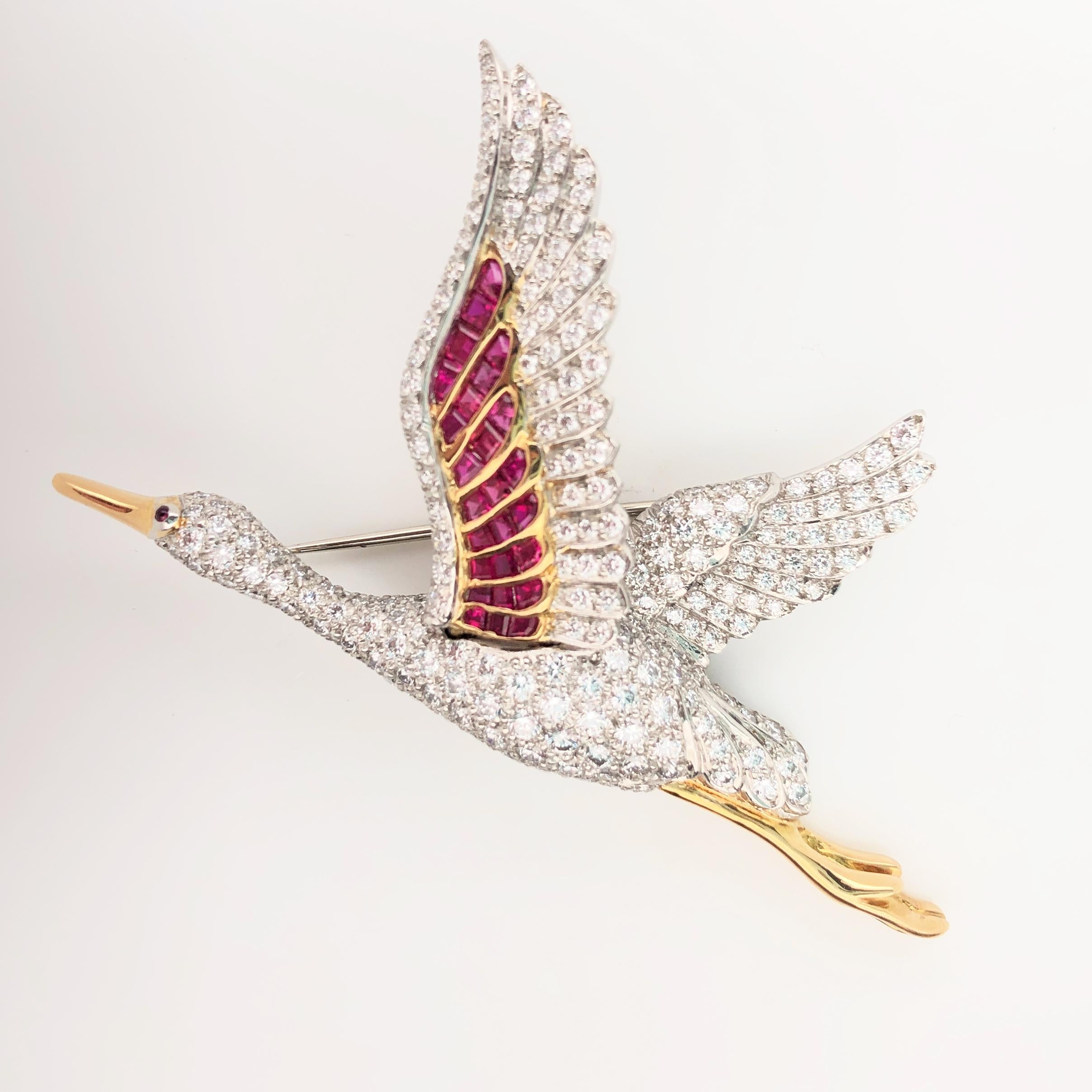 Oscar Heyman 18kt yellow gold and platinum flying egret bird brooch contains 245 round diamonds weighing 3.87cts (F-G/VS+), 26 square rubies weighing 1.16cts, and 1 cabochon ruby as the eye. The wing with rubies can 'flap' slightly. It is stamped